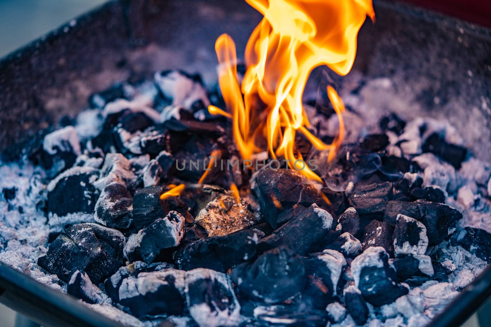 A close up of a fire from a barbecue or fire pit