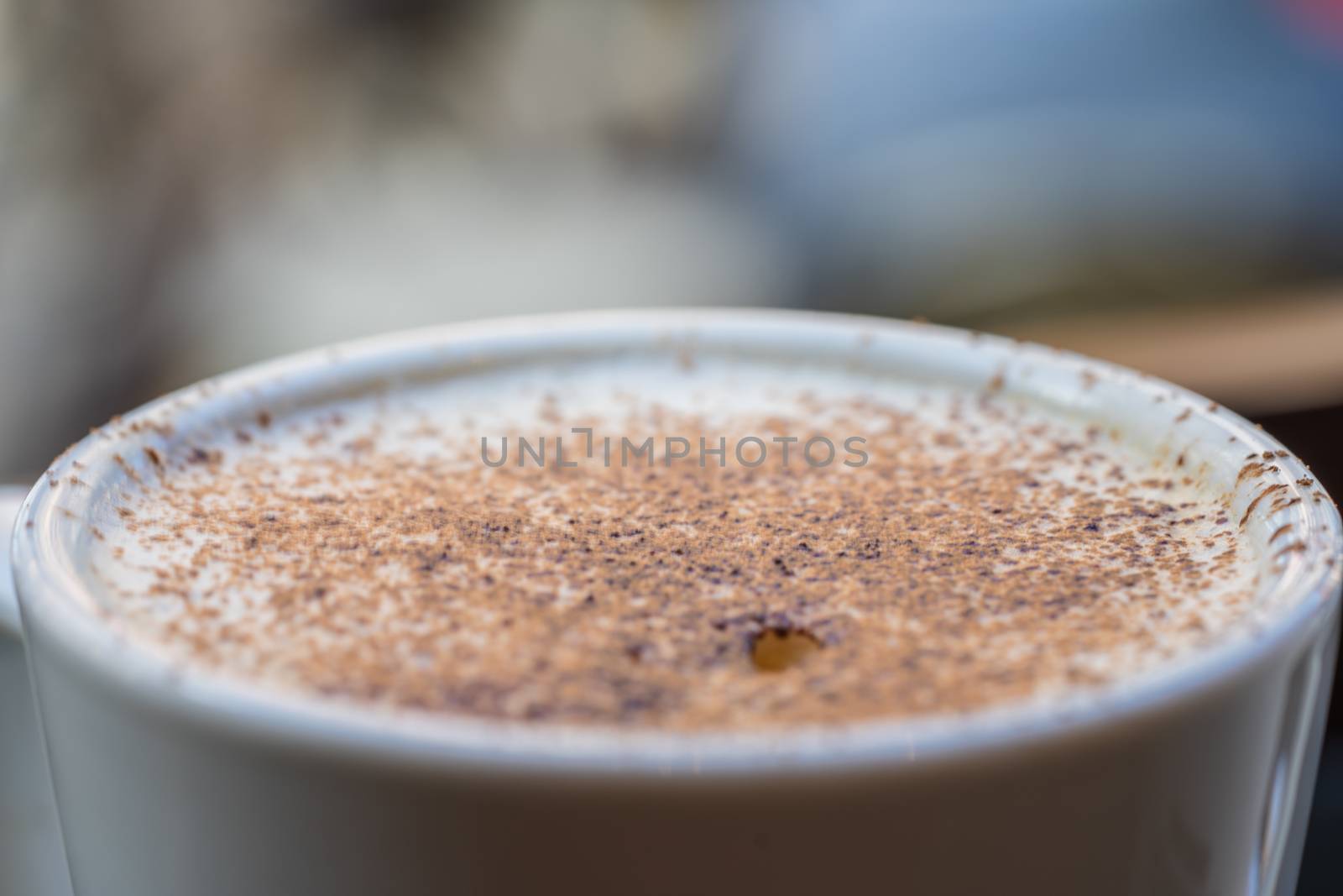 A cup of cappuccino coffee in a cafe setting