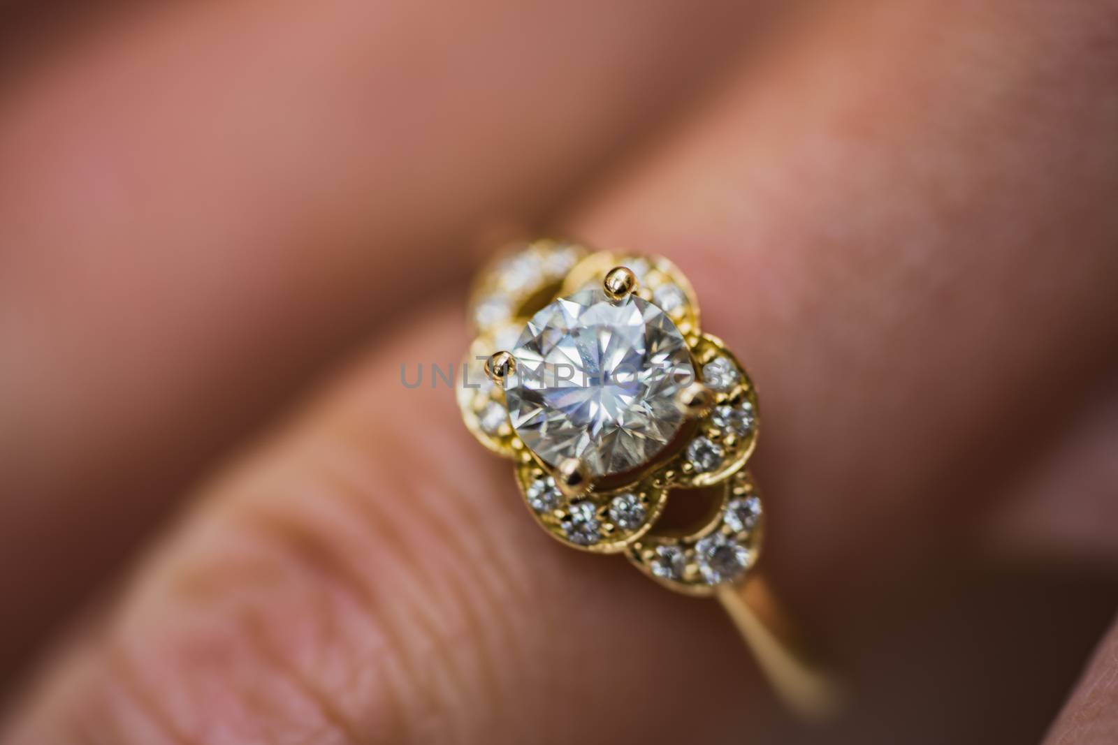 A close up of a beautiful gold diamond engagement ring