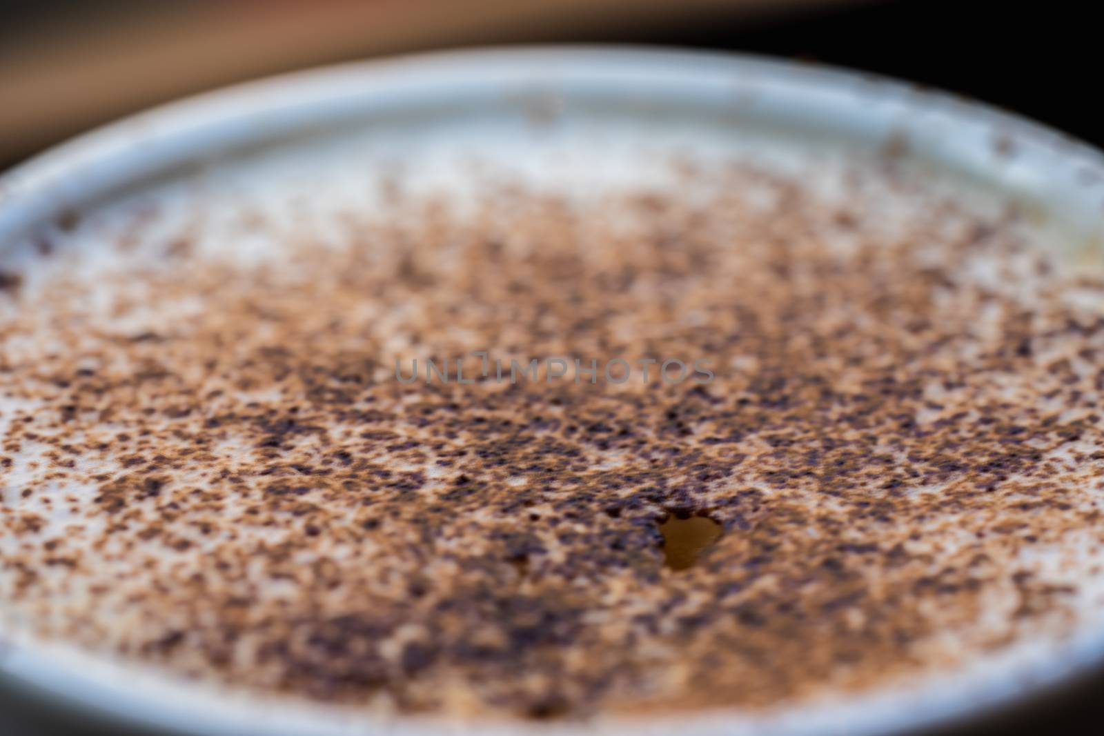 A cup of cappuccino coffee in a cafe setting