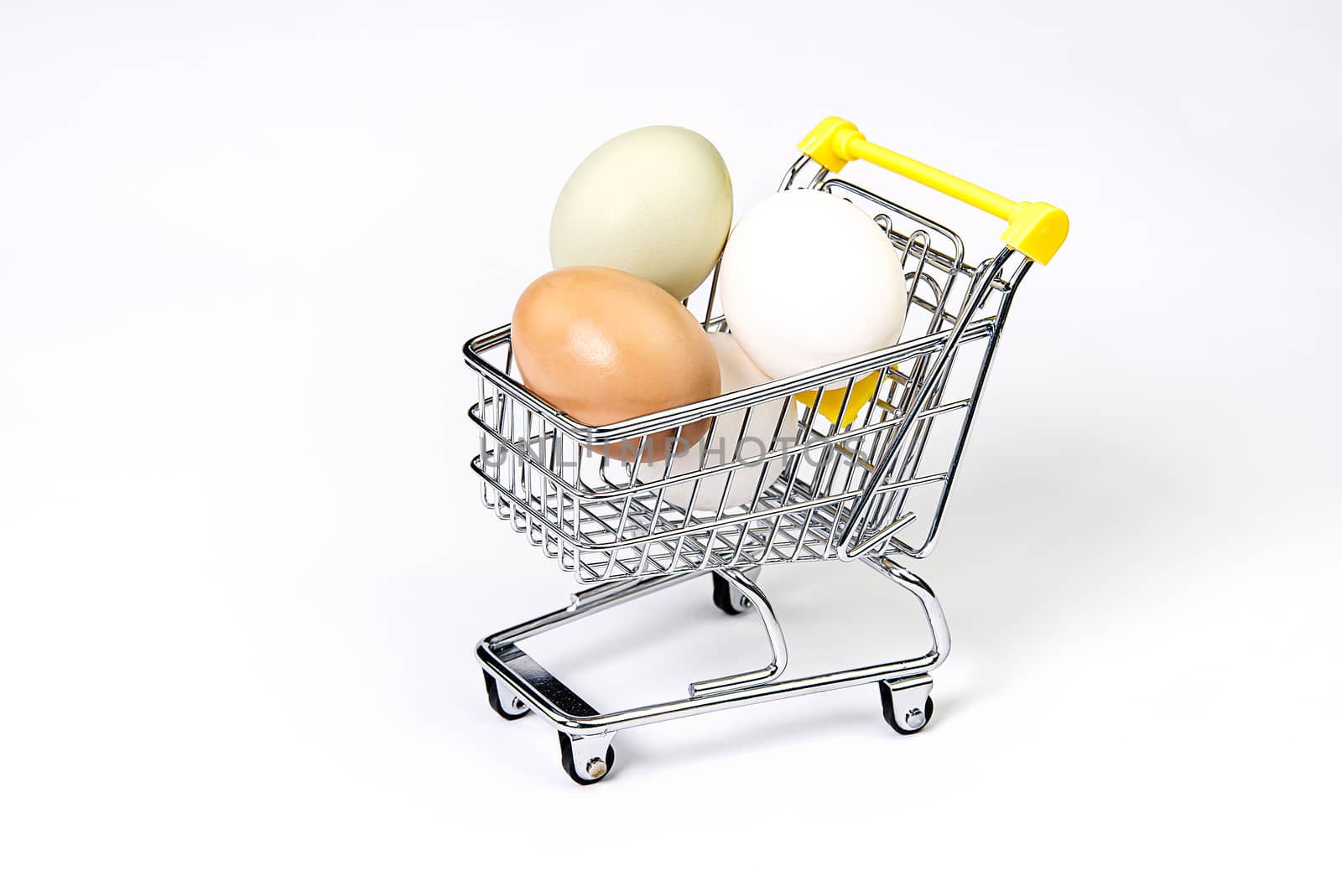 chicken colored eggs in a shopping cart isolated on white