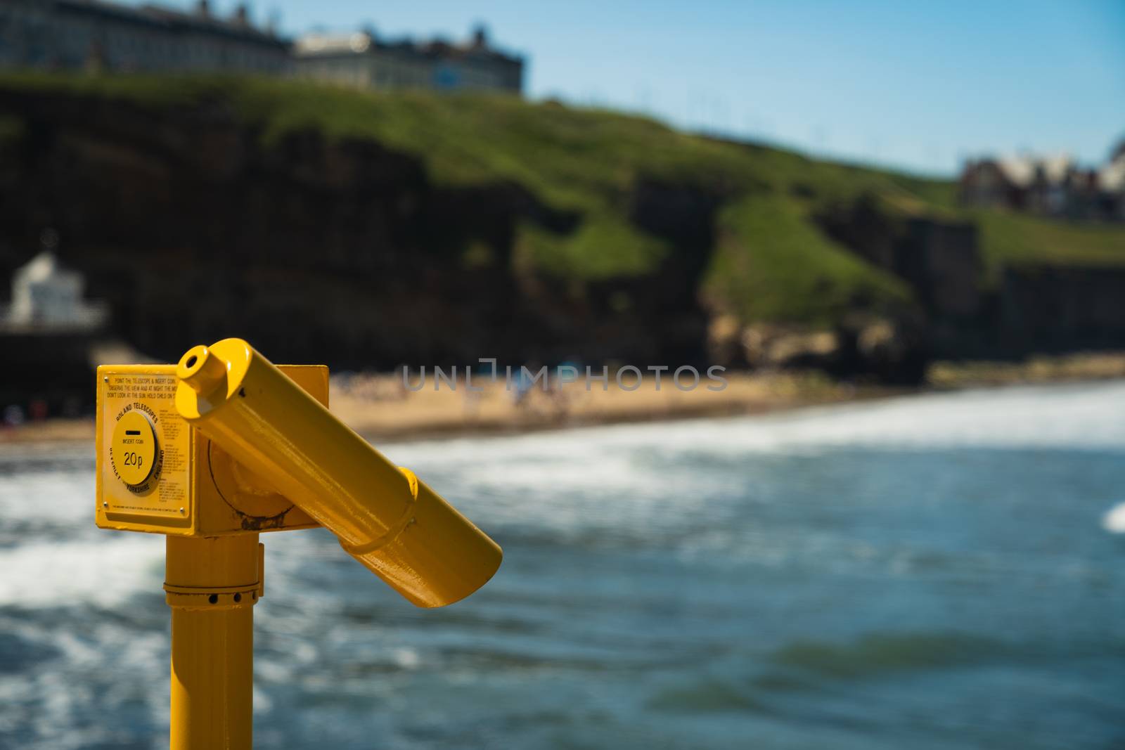 A seaside pair of yellow binoculars at a local beach in Yorkshire