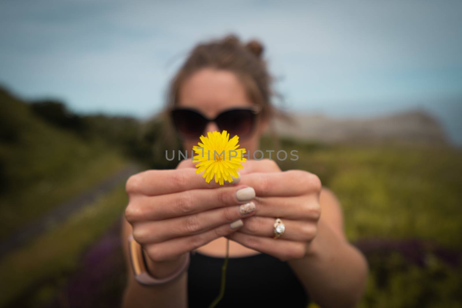 Woman Holding Yellow Flower by samULvisuals