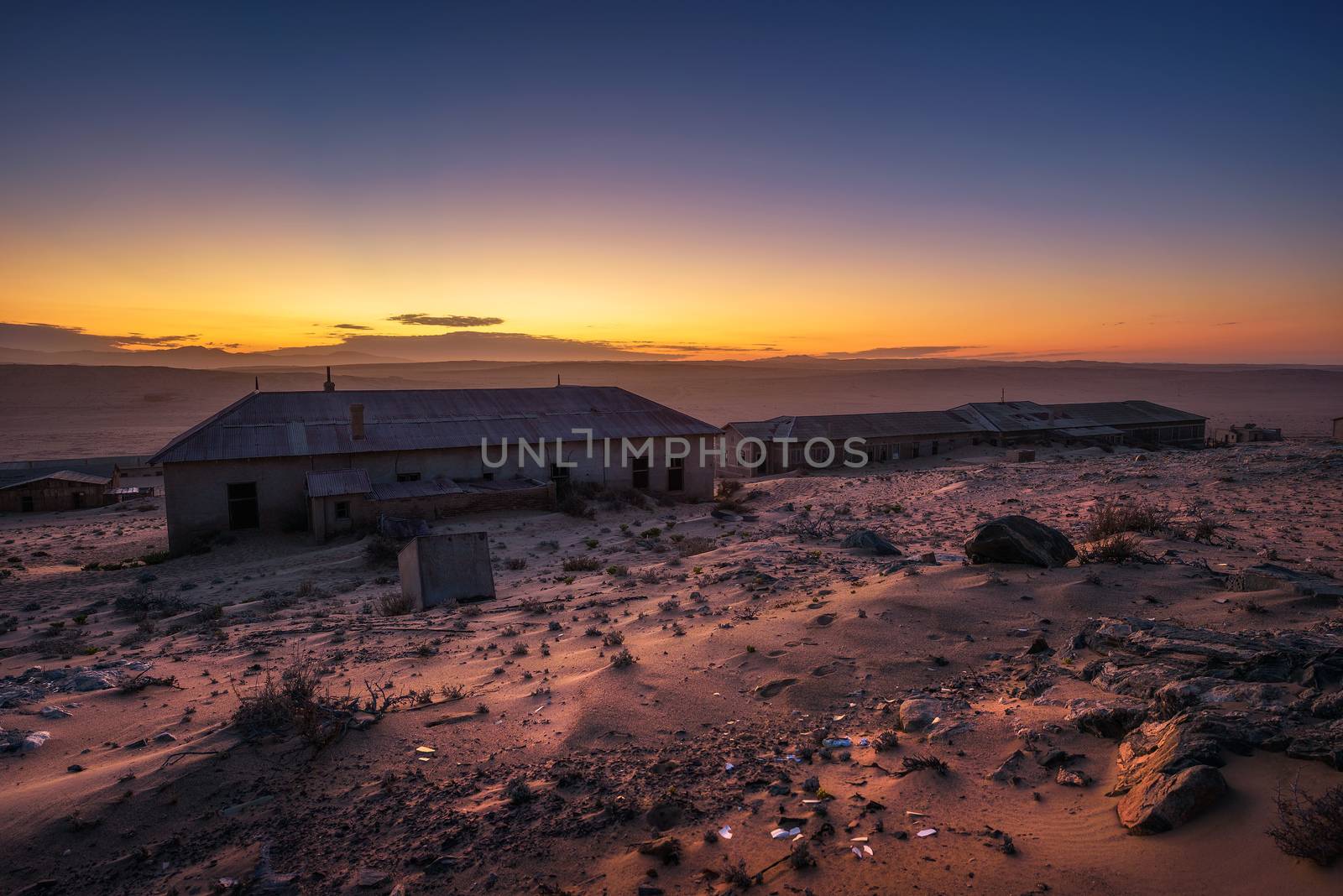 Sunrise above the abandoned houses of Kolmanskop ghost town, Namibia. by nickfox