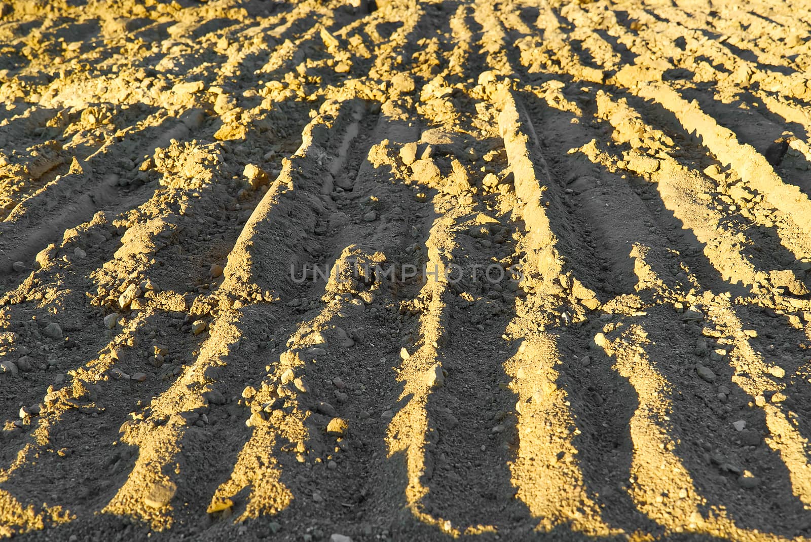 Excavator tracks on the ground texture. Mud ground earth soil trace tracks marks markings dry surface texture