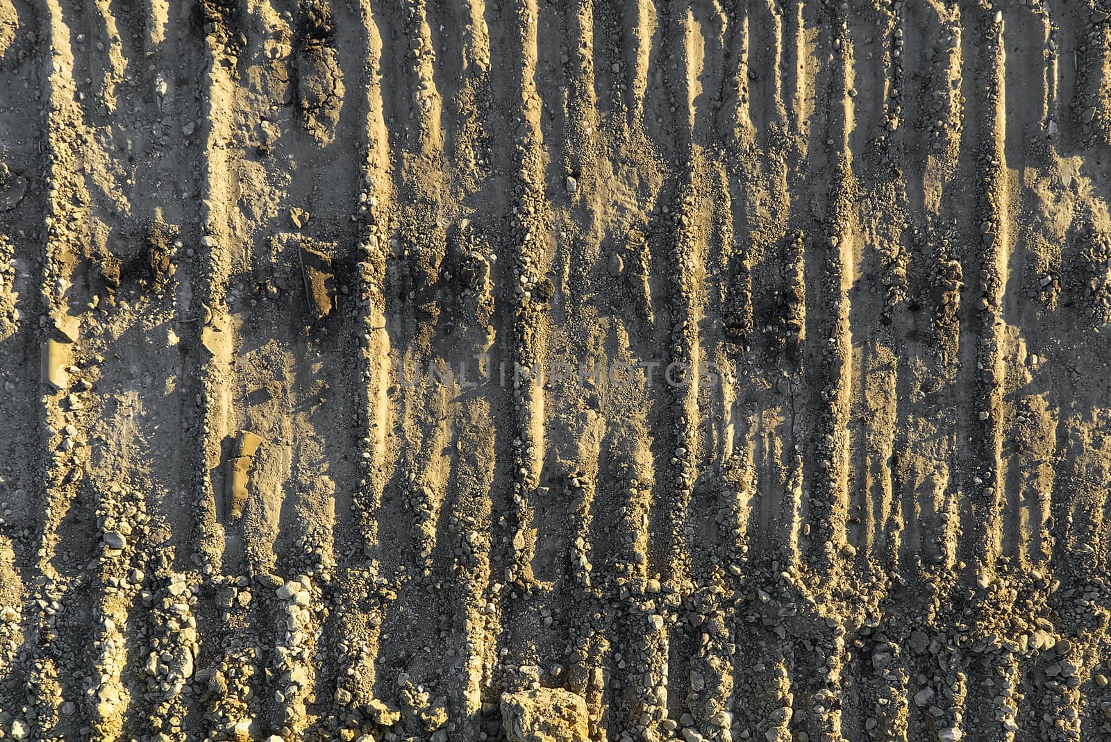 Excavator tracks on the ground texture. Mud ground earth soil trace tracks marks markings dry surface texture. by PhotoTime