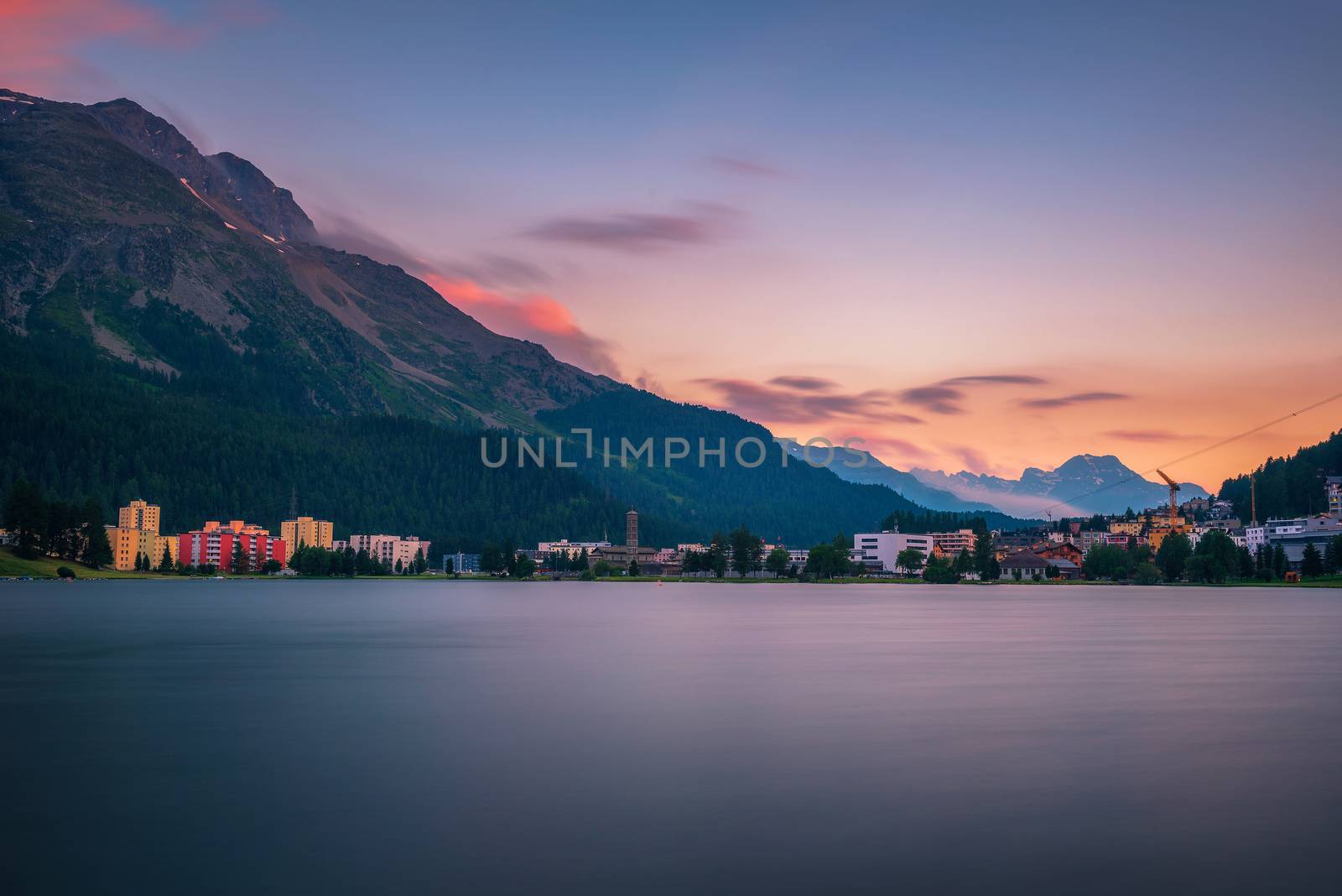 Sunset above St. Moritz with lake also called St. Moritzsee and Swiss Alps in the background in Engadin, Switzerland. Long exposure.