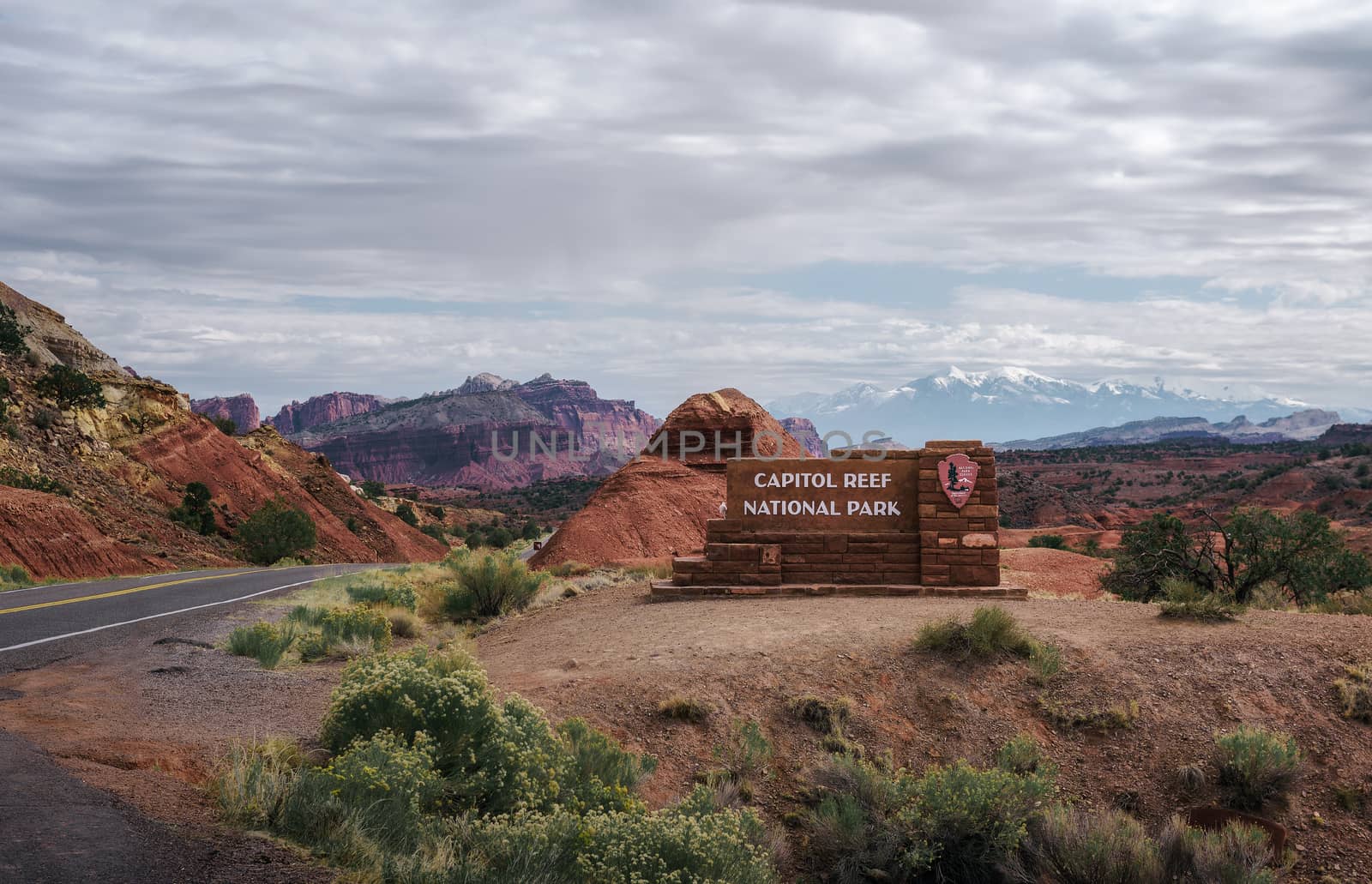 Capitol Reef National Park, Utah, USA - October 20, 2018 : Welcome sign at the entrance to Capitol Reef National park, Utah, with snow covered Rocky Mountains in the background.