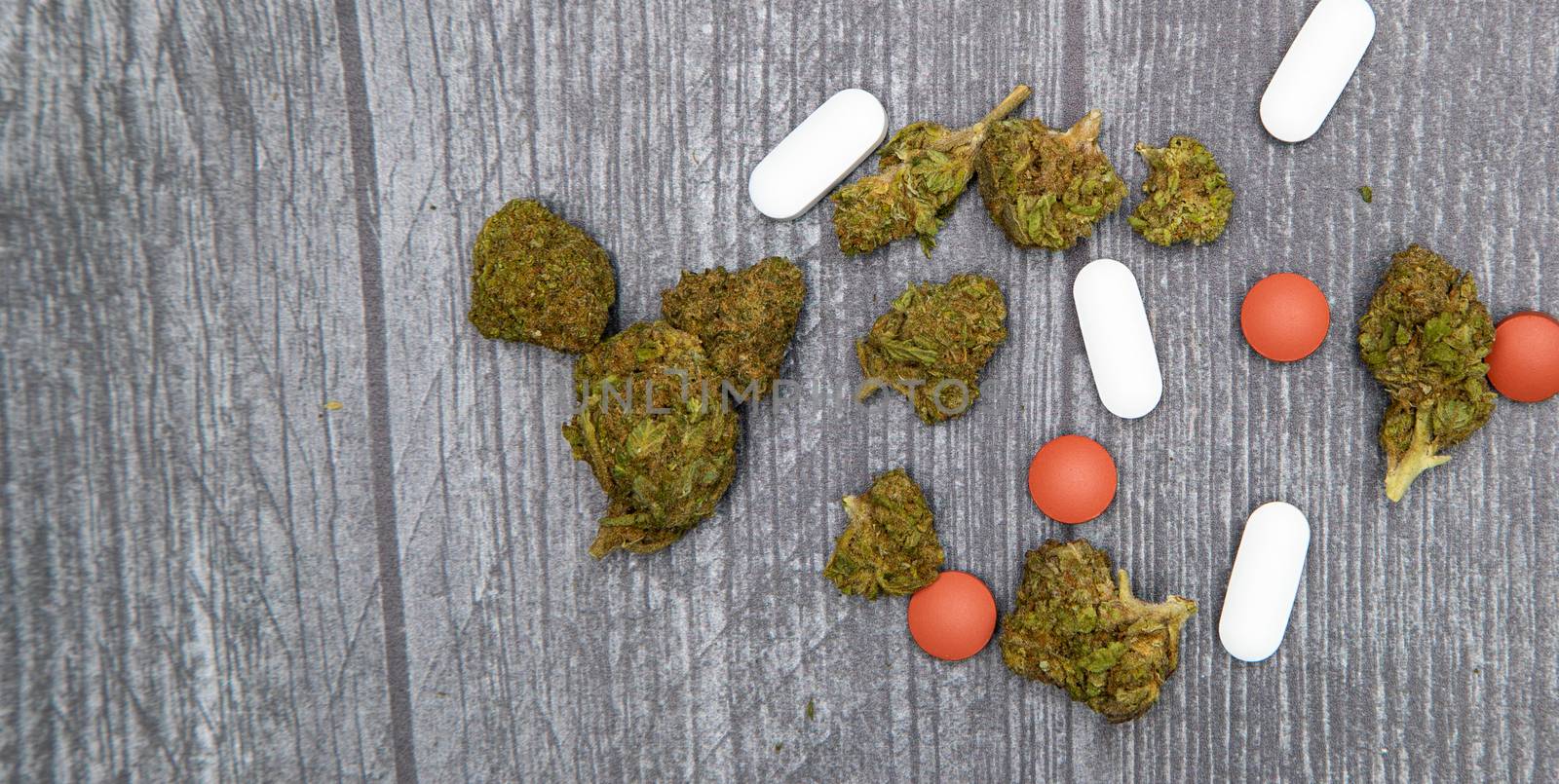 A closeup of our modern day pain remedies. Marijuana, ibuprofen, pain pills.
