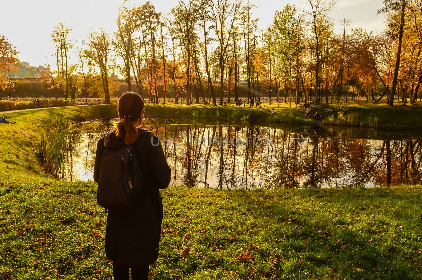 Young woman look at the forest pond by chernobrovin