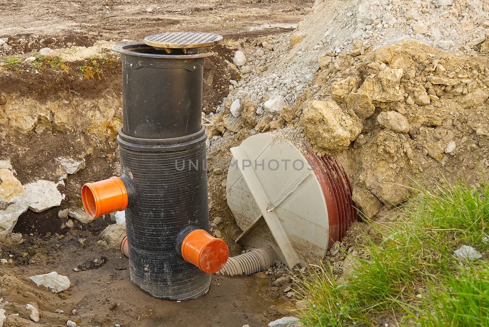 construction of a drainage ditch with plastic pipes. development of a new residential area in the field