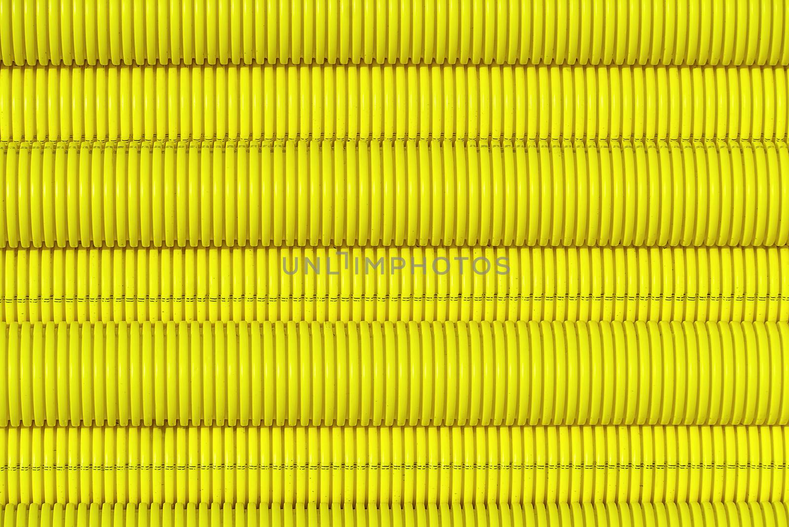 yellow plastic pipes for laying electricity cables underground. texture or abstract background