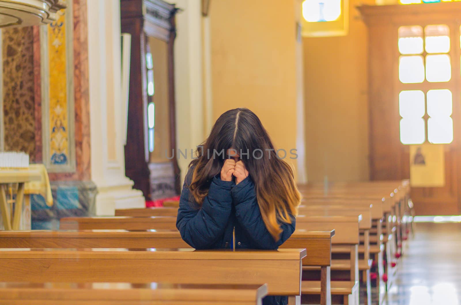 christian woman praying in catholic church by chernobrovin