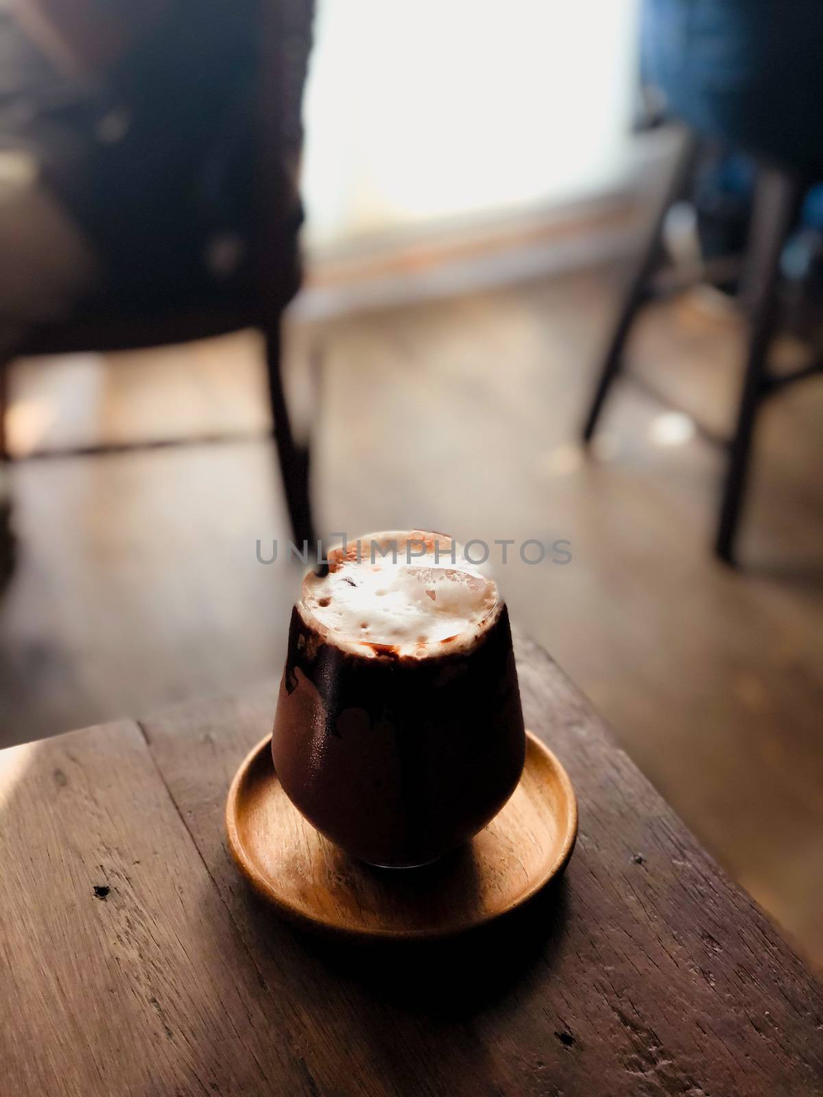 close up modern hot black chocolate in cup looking and feel so delicious on woodenr table in coffee shop. by Benzoix