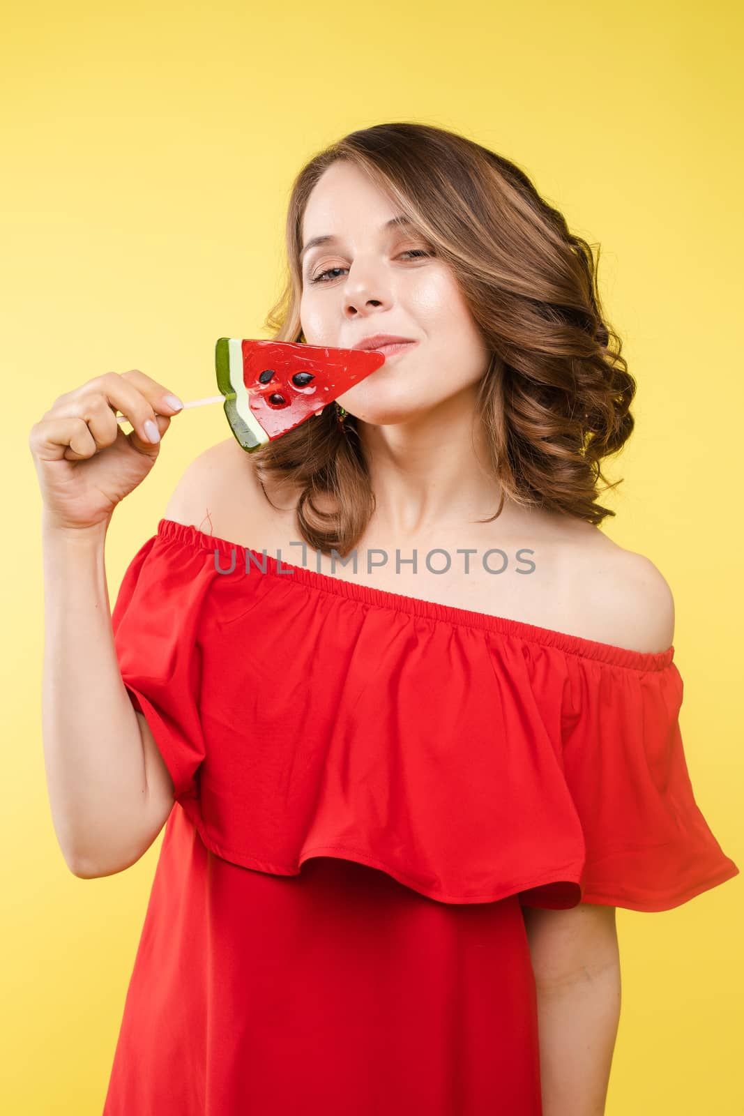 Fashionable young woman with lolipop in her hands on background by StudioLucky