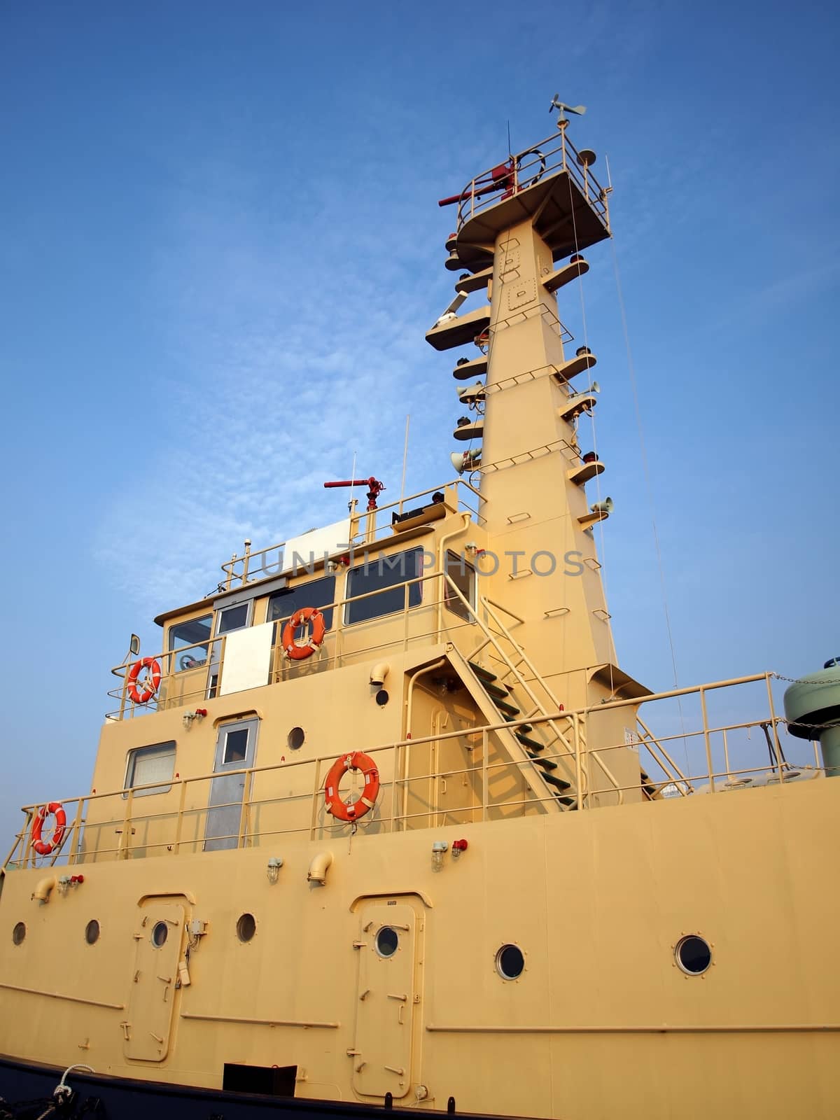 The mid section of a harbor patrol vessel with its communication tower
