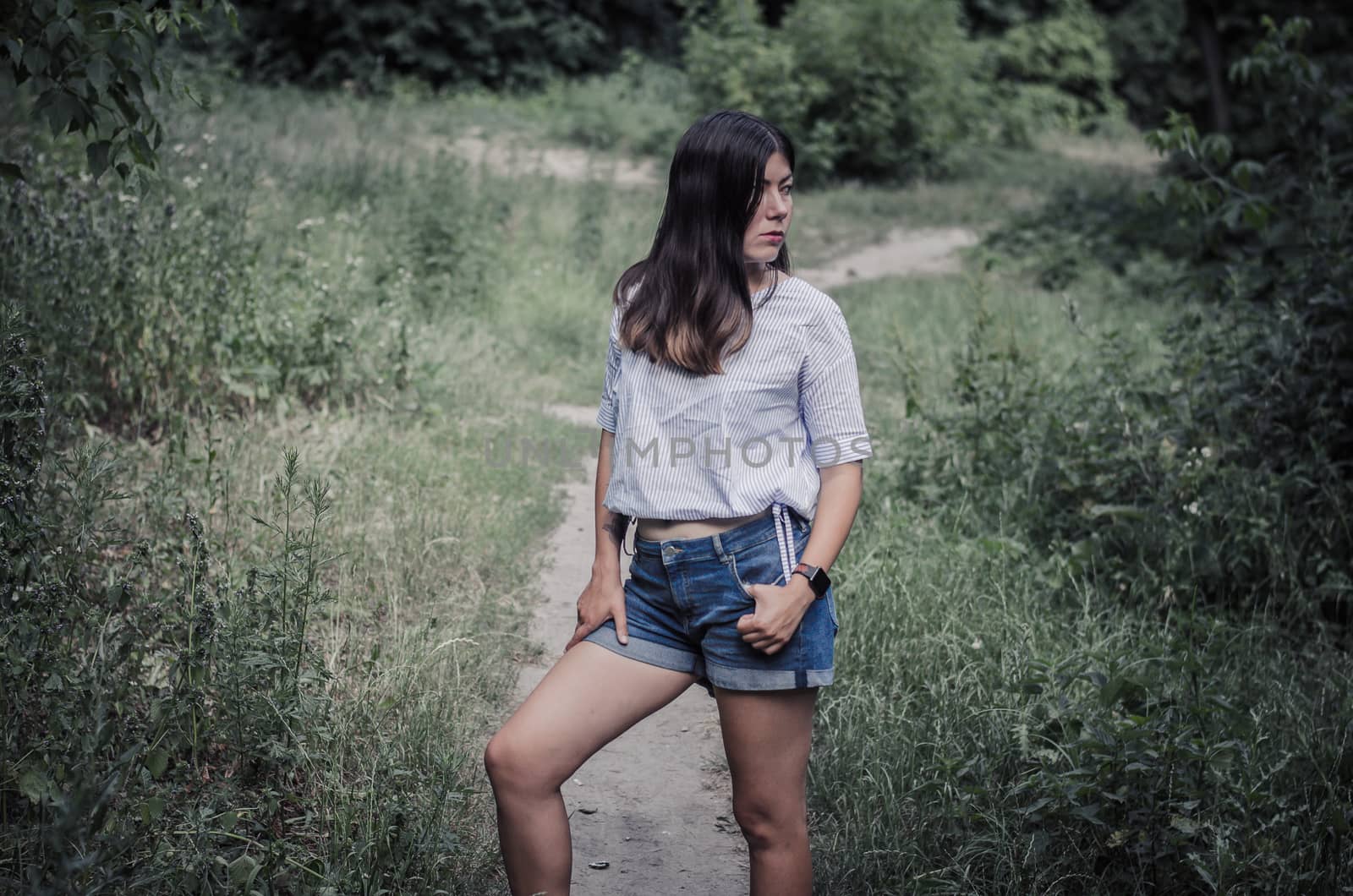 Young woman with long dark hair in the forest