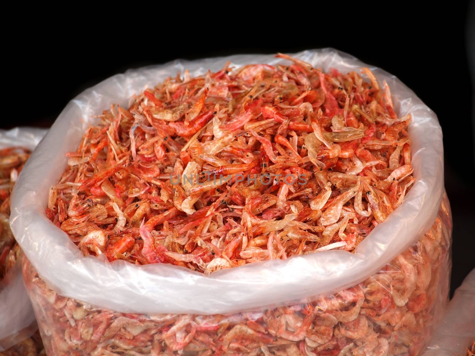 Large sack with dried shrimps for sale at an outdoor market