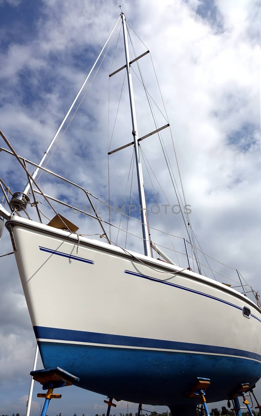 A sailing yacht is placed on a scaffold for repair and maintenance