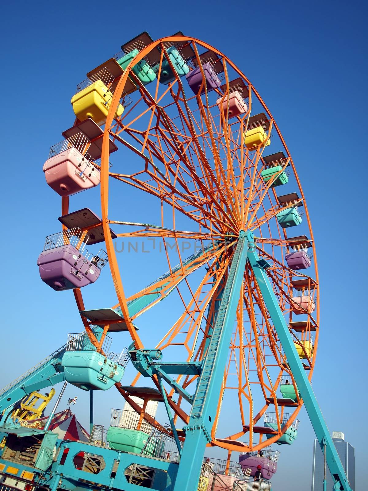 A ferris wheel with colorful cabins at a local fun fair
