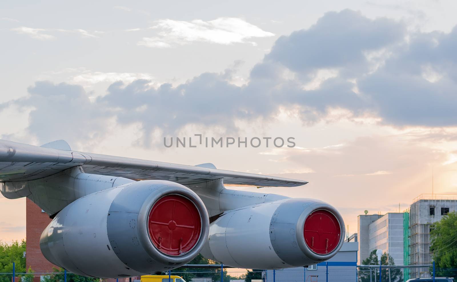 aircraft wing with engines in the Parking lot on the background of the city area