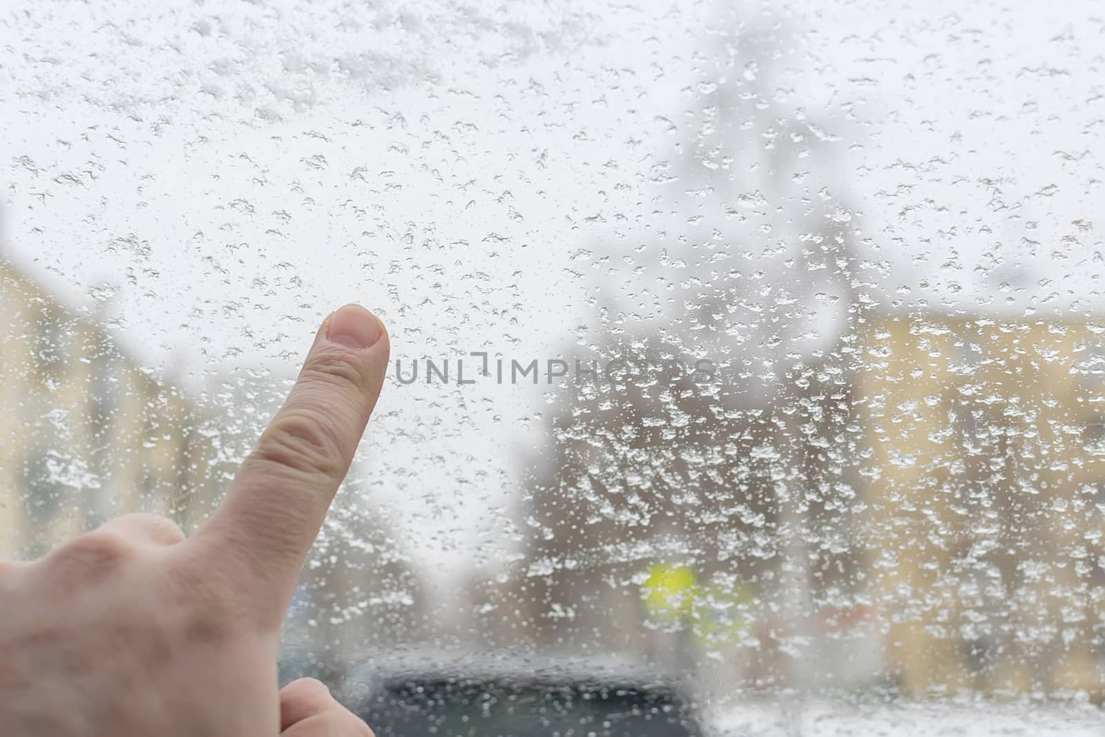 man finger touches the icy glass of the car by jk3030