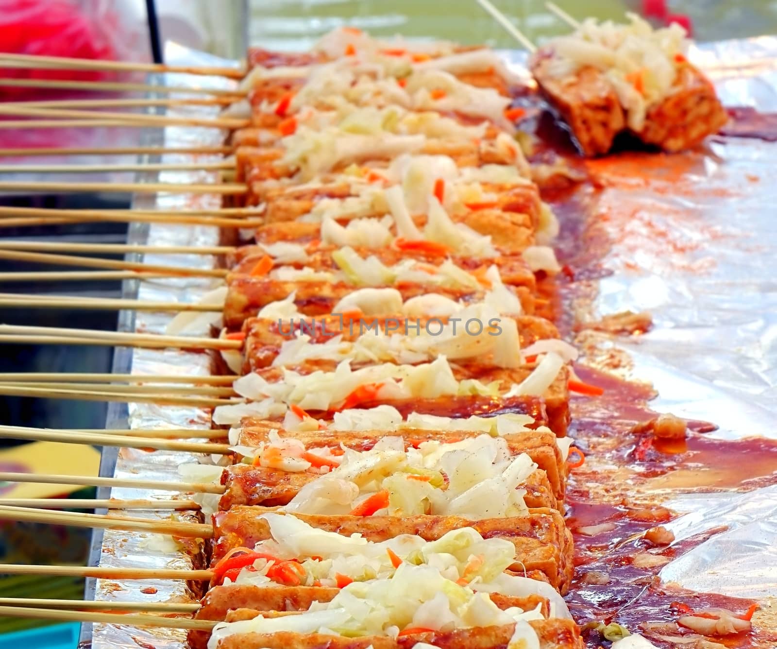 Stinky fermented tofu skewers with pickled cabbage and hot sauce is popular in Taiwan