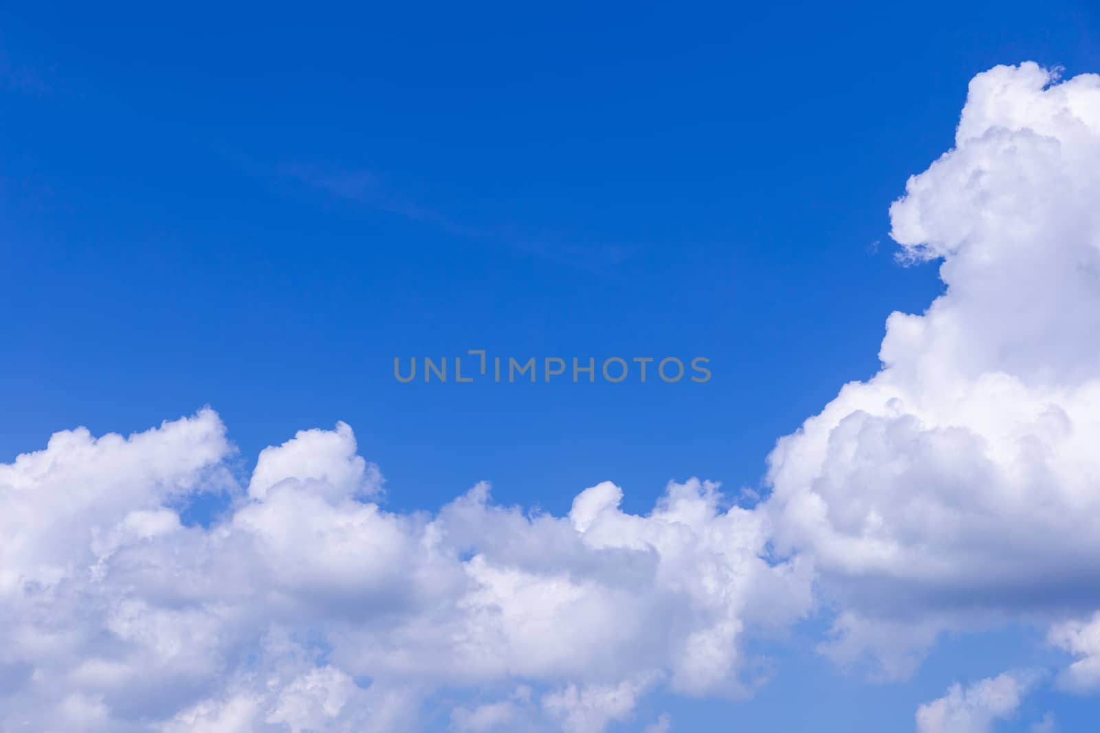 Blue sky background with white clouds on sunny day.