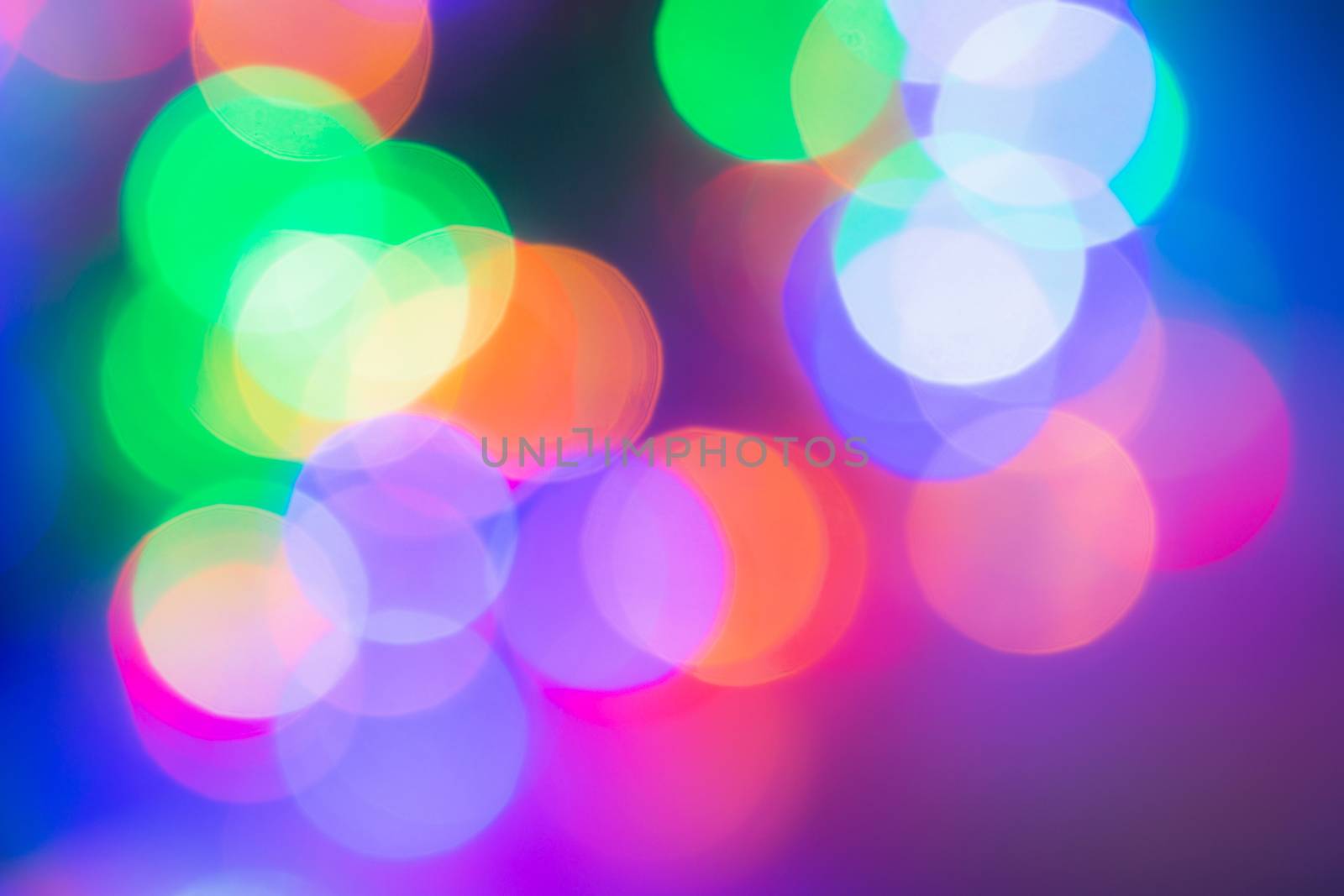 Colorful abstract blurred circular bokeh light of night city street by phanthit