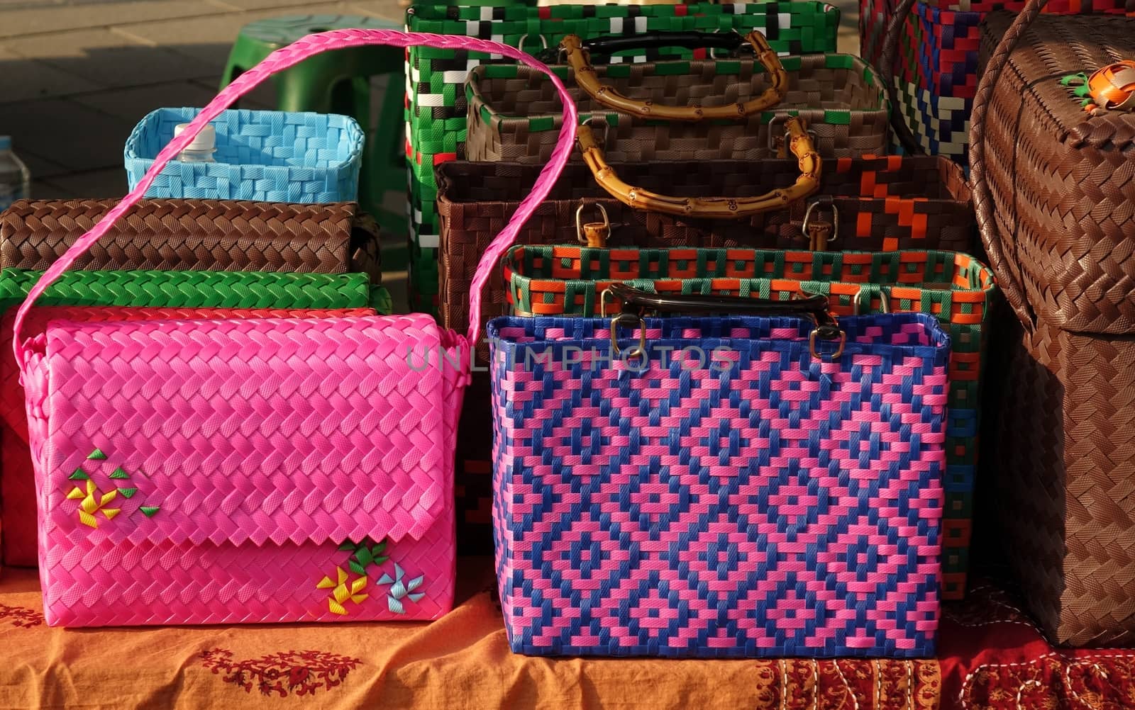 Hand crafted bags for ladies are sold at an outdoor market
