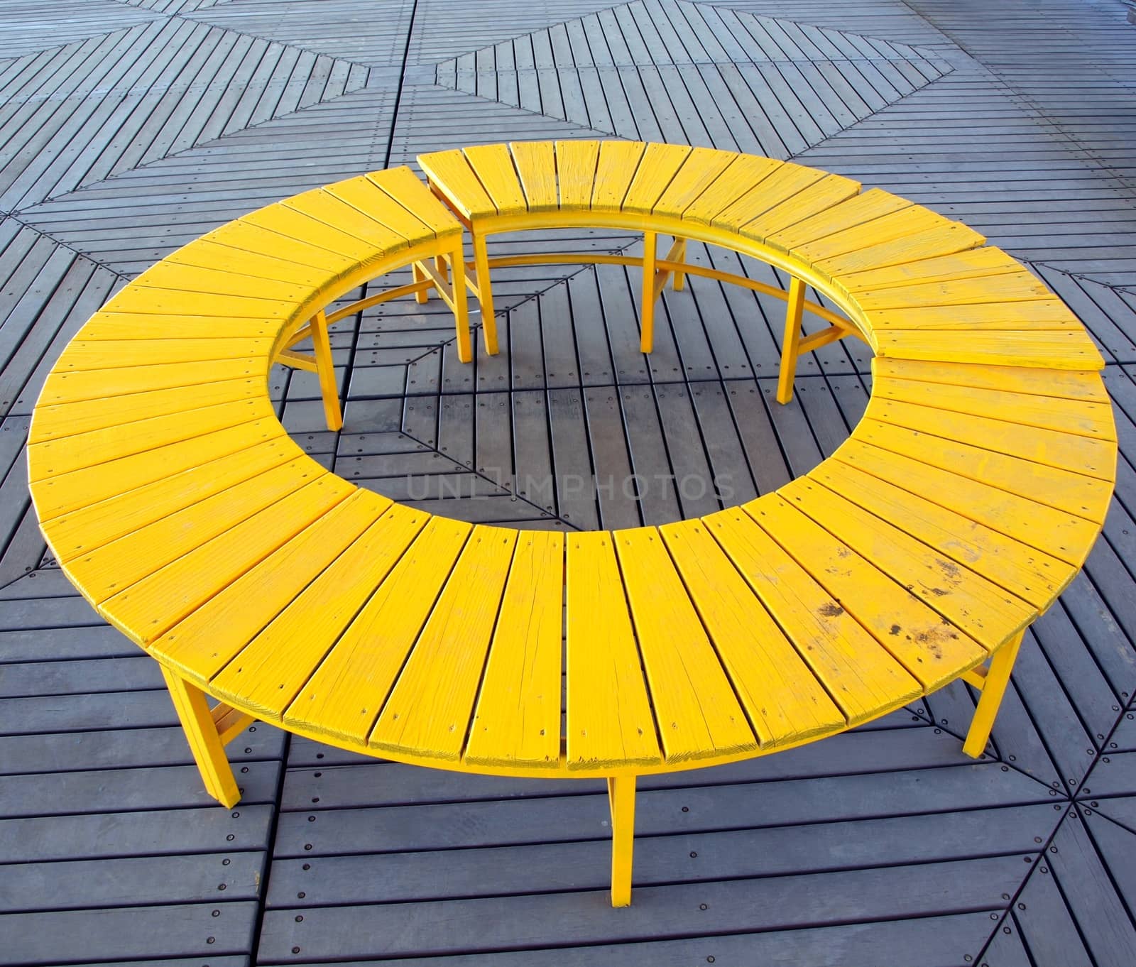 A unique wooden bench in the shape of a circle
