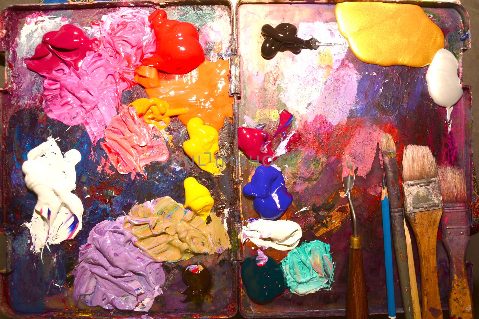 Paintbrushes and Palette-knife on the palette for mixing oil paints