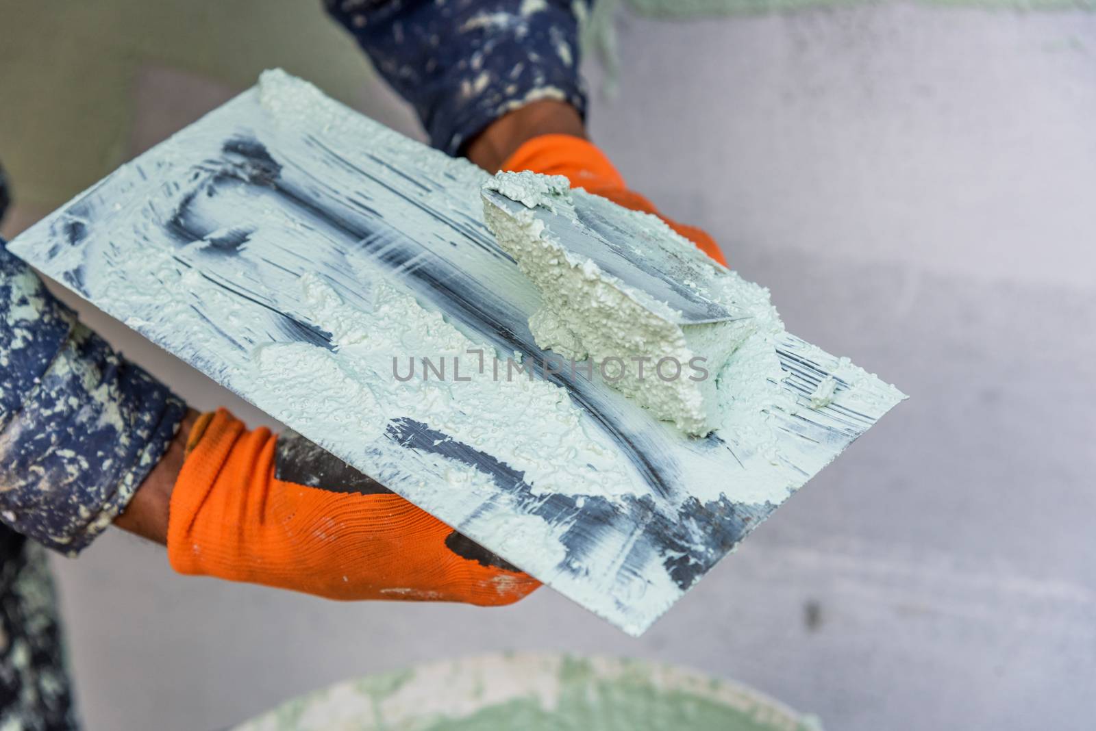 Application Of Facade Plaster,Worker Plastering The Facade Of The Building, Close-Up.