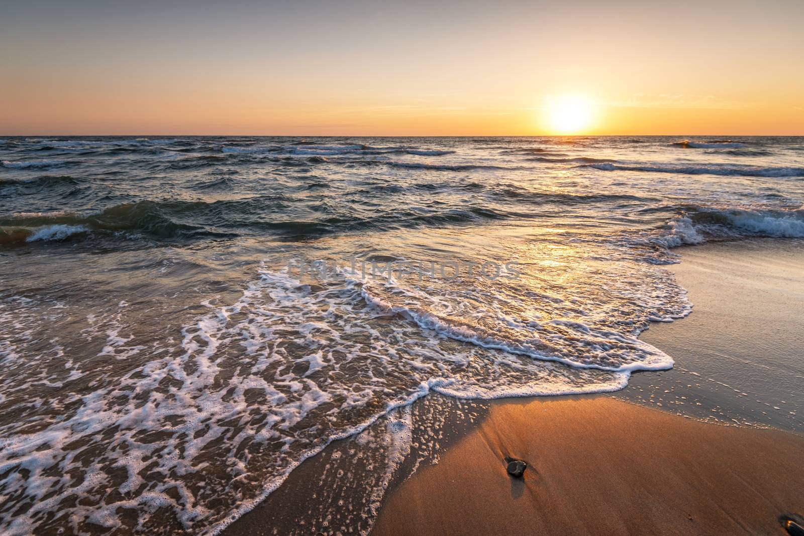 Waves at sunset at mediterranean sea.