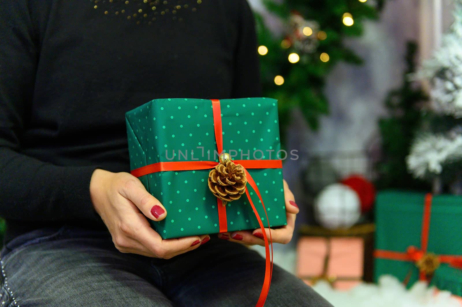 Female's hands in pullover holding Christmas gift box.Christmas and New Year banner.