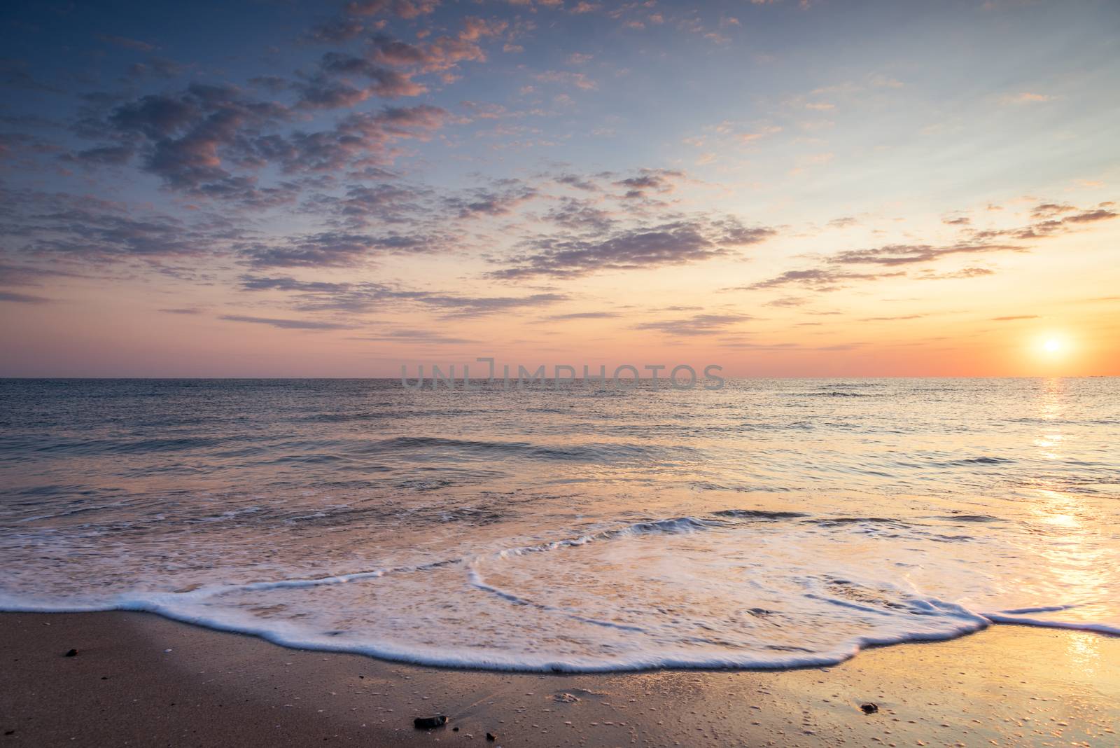 Waves at sunset at mediterranean sea.