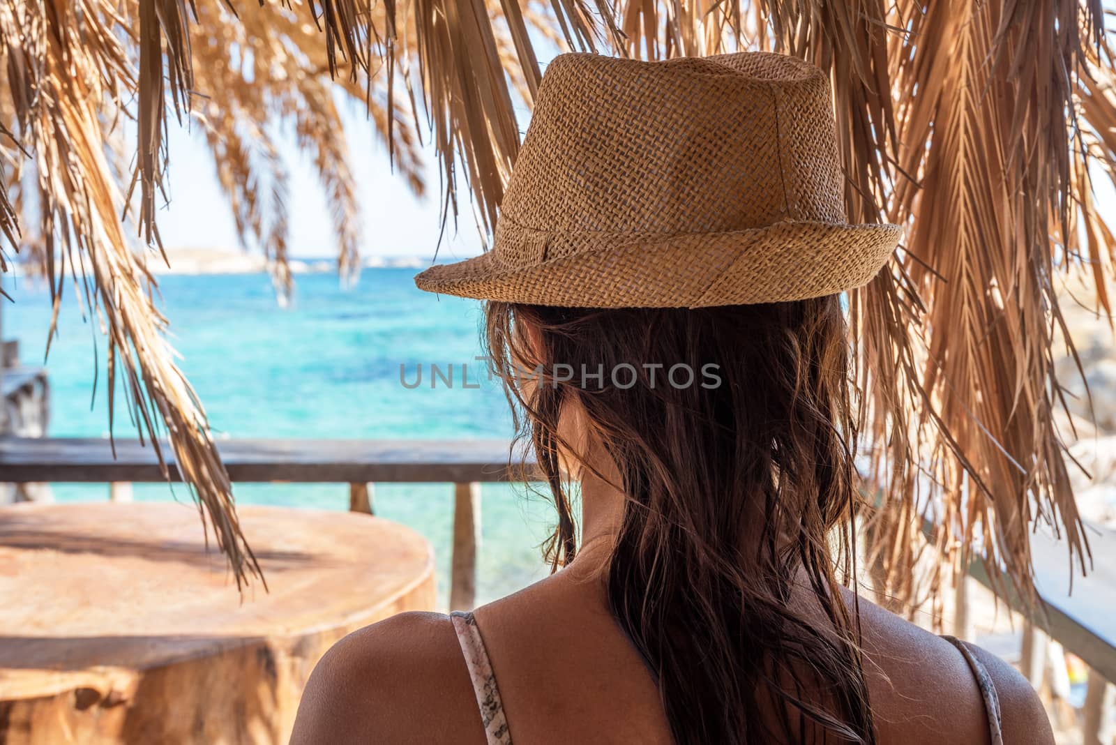 Happy tourist girl with hat on sea.