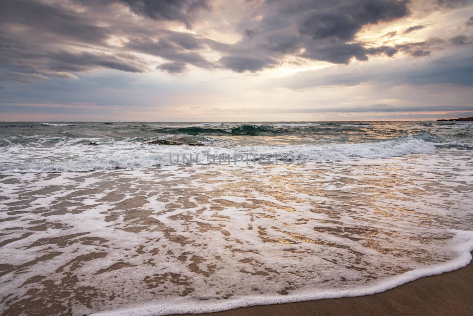 Waves at sunset at mediterranean sea.