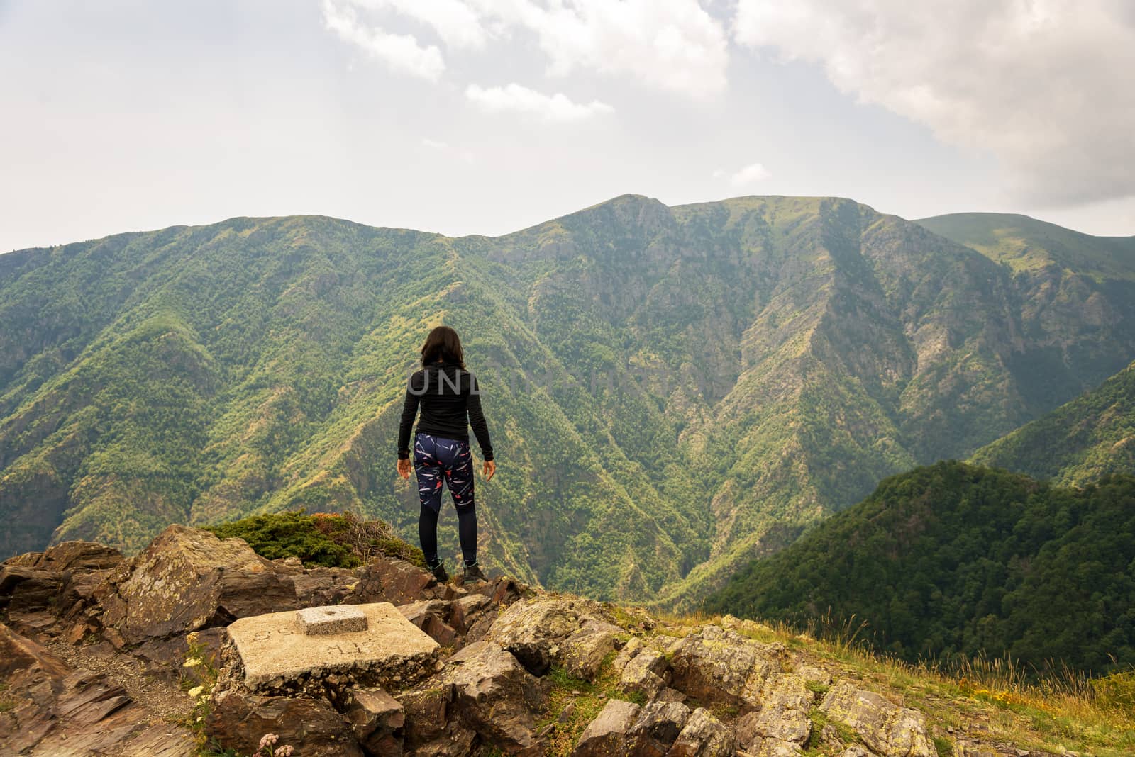 Lone active woman at the edge of the cliff, Central balkan, Bulgaria.