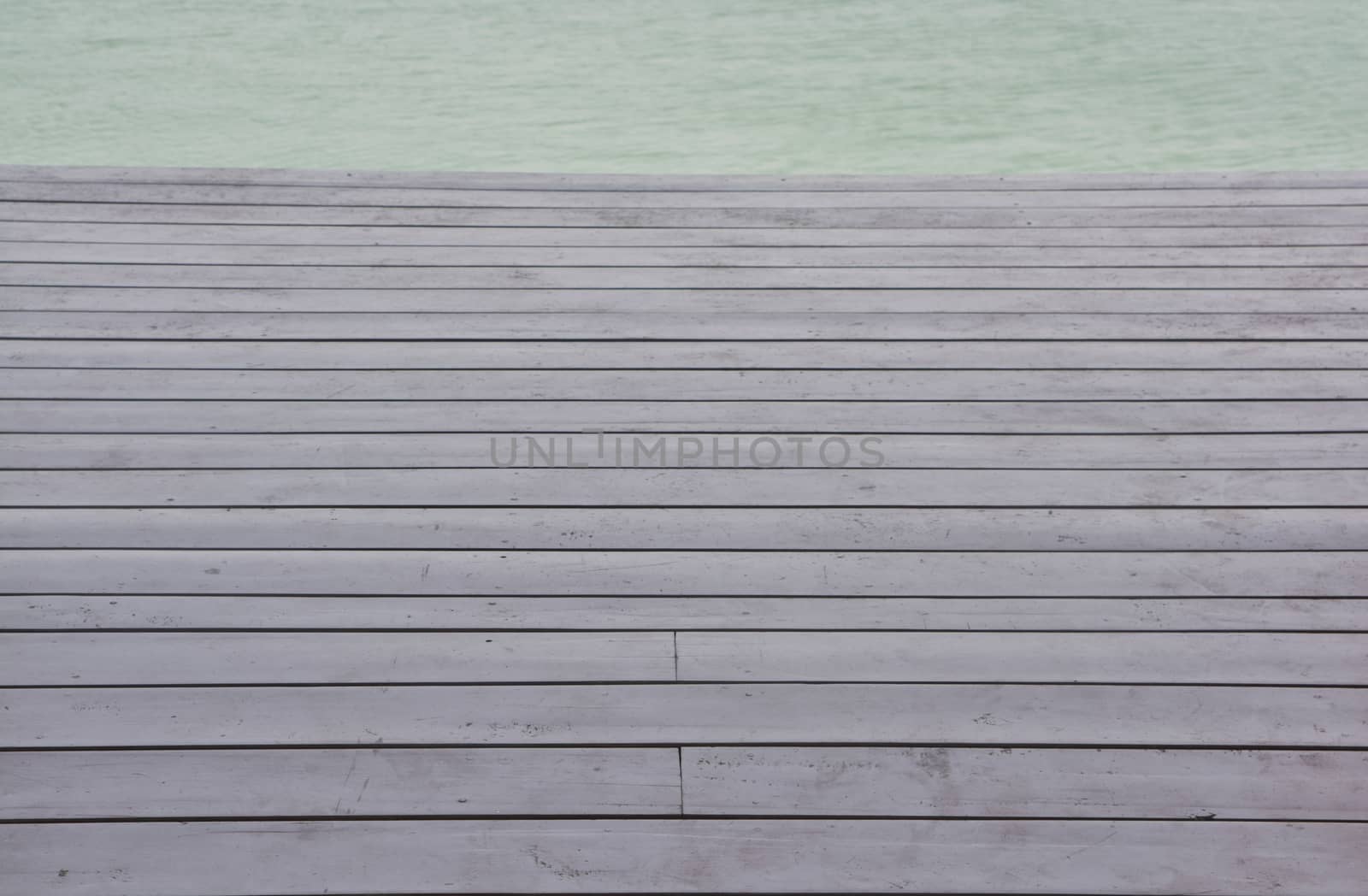 wooden platform beside blue sky beach by ideation90