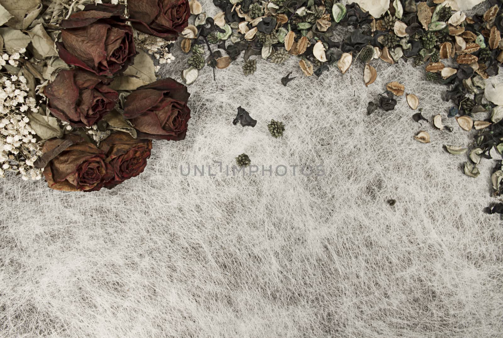 Romantic background in soft autumn colors with dried roses and pot pourri on white rice paper