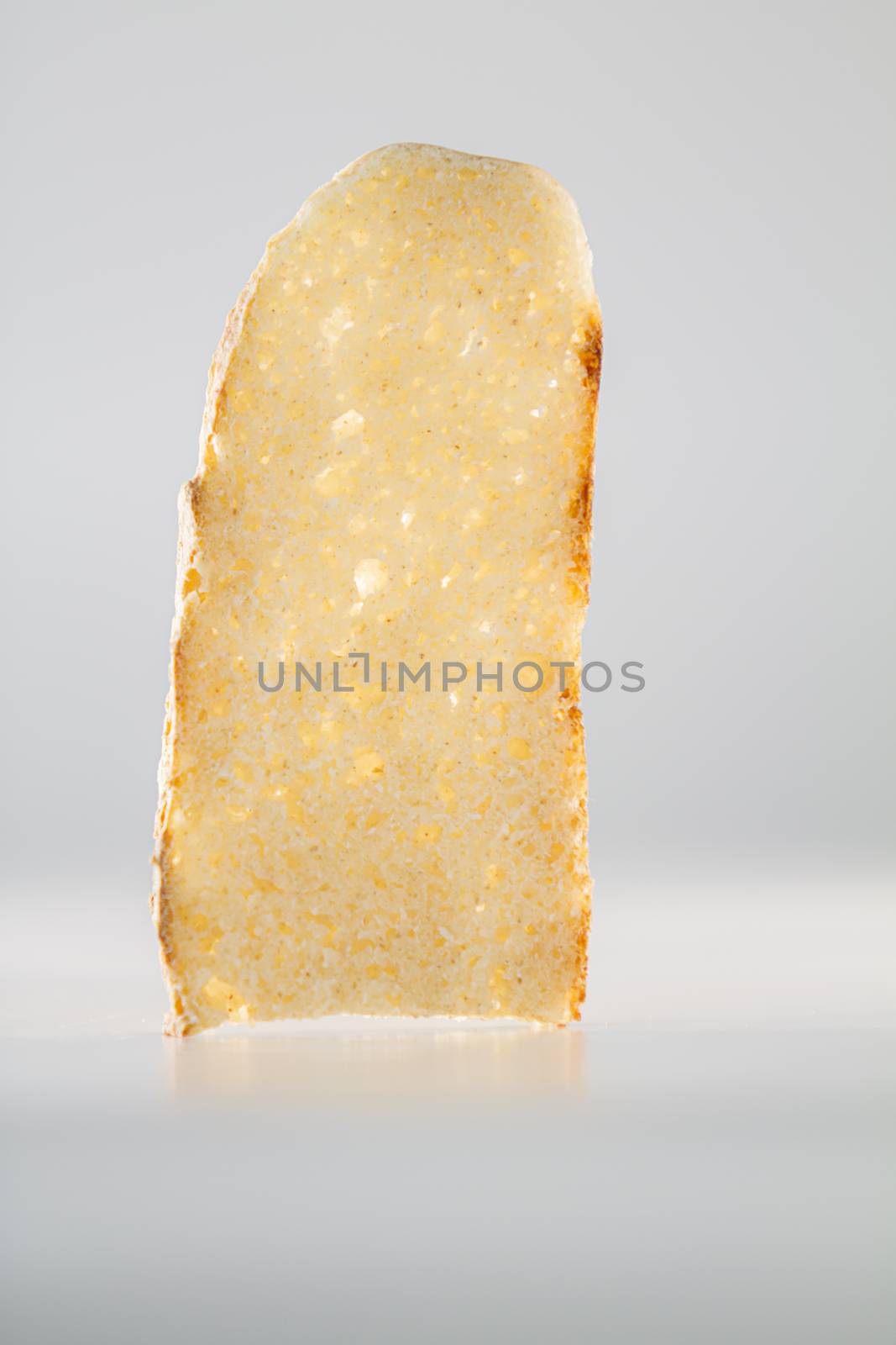 The purity and simplicity of a slice of homemade bread highlighted by the back lighting