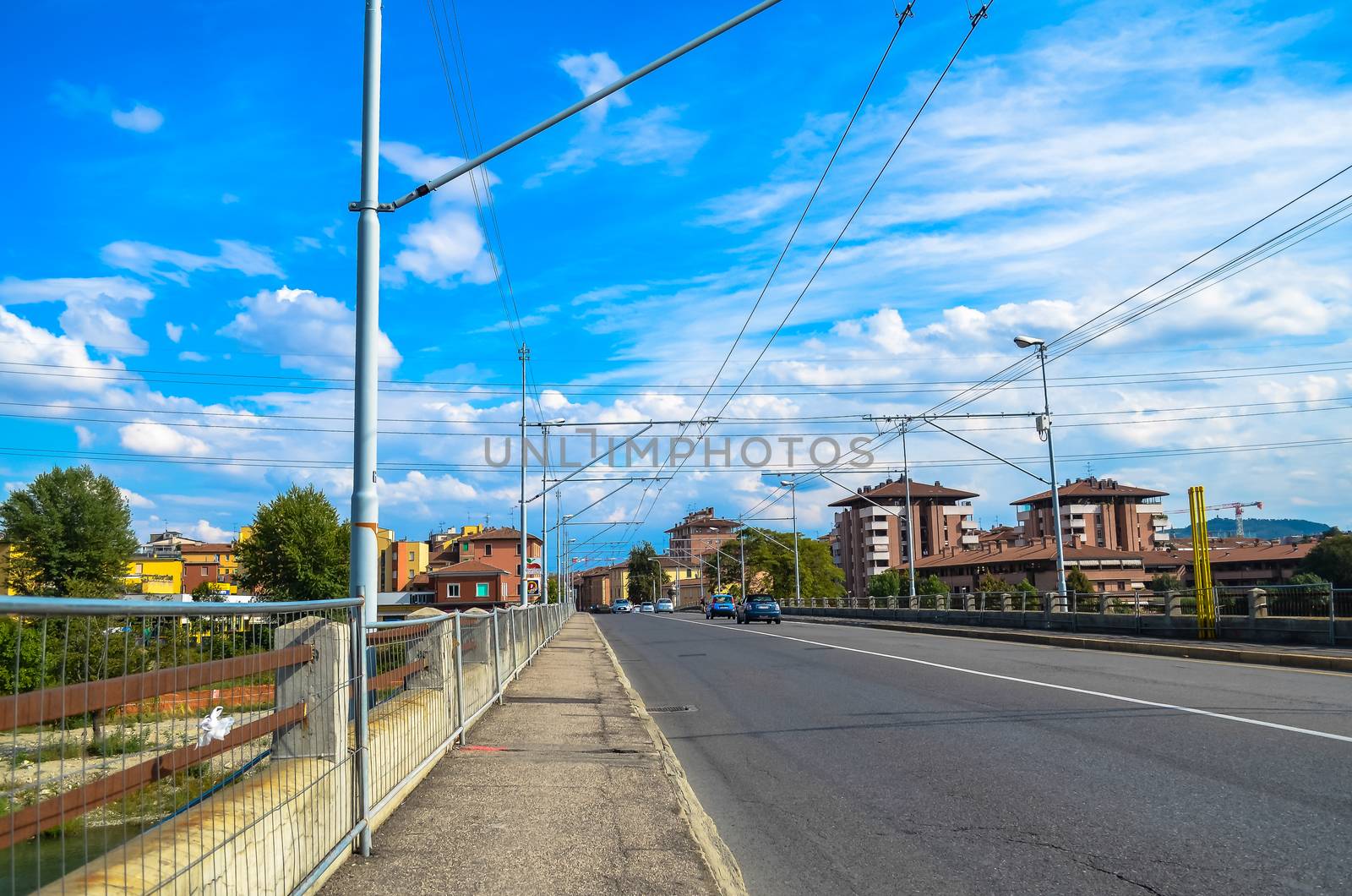 road on a bridge with houses in the background. Bologna, Italy by chernobrovin