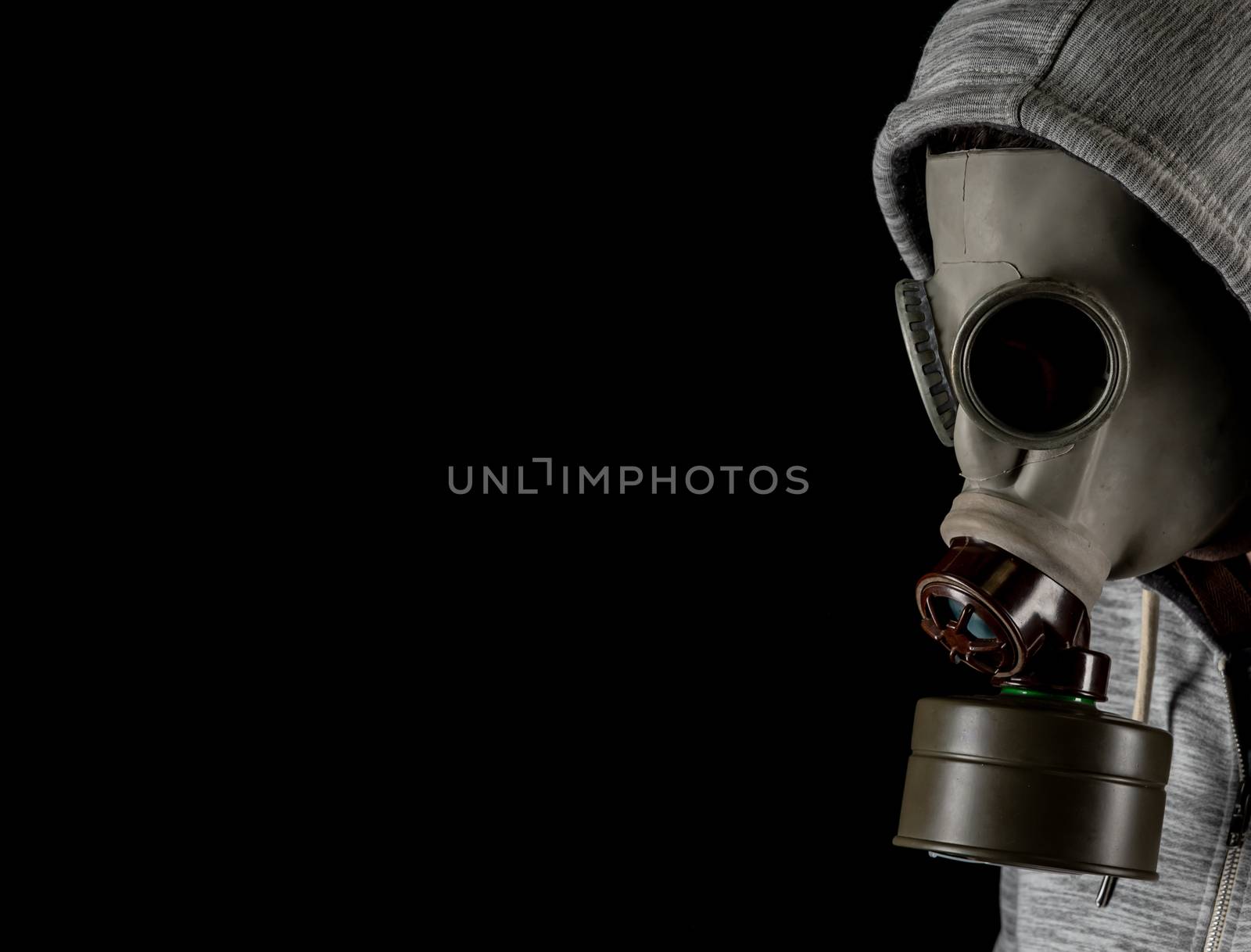 man in a gas mask on a black background. protection against viruses