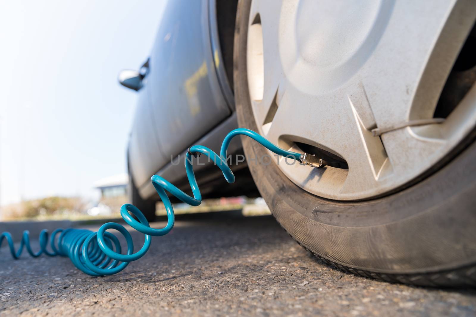 inflating the wheels of the car at gas station.