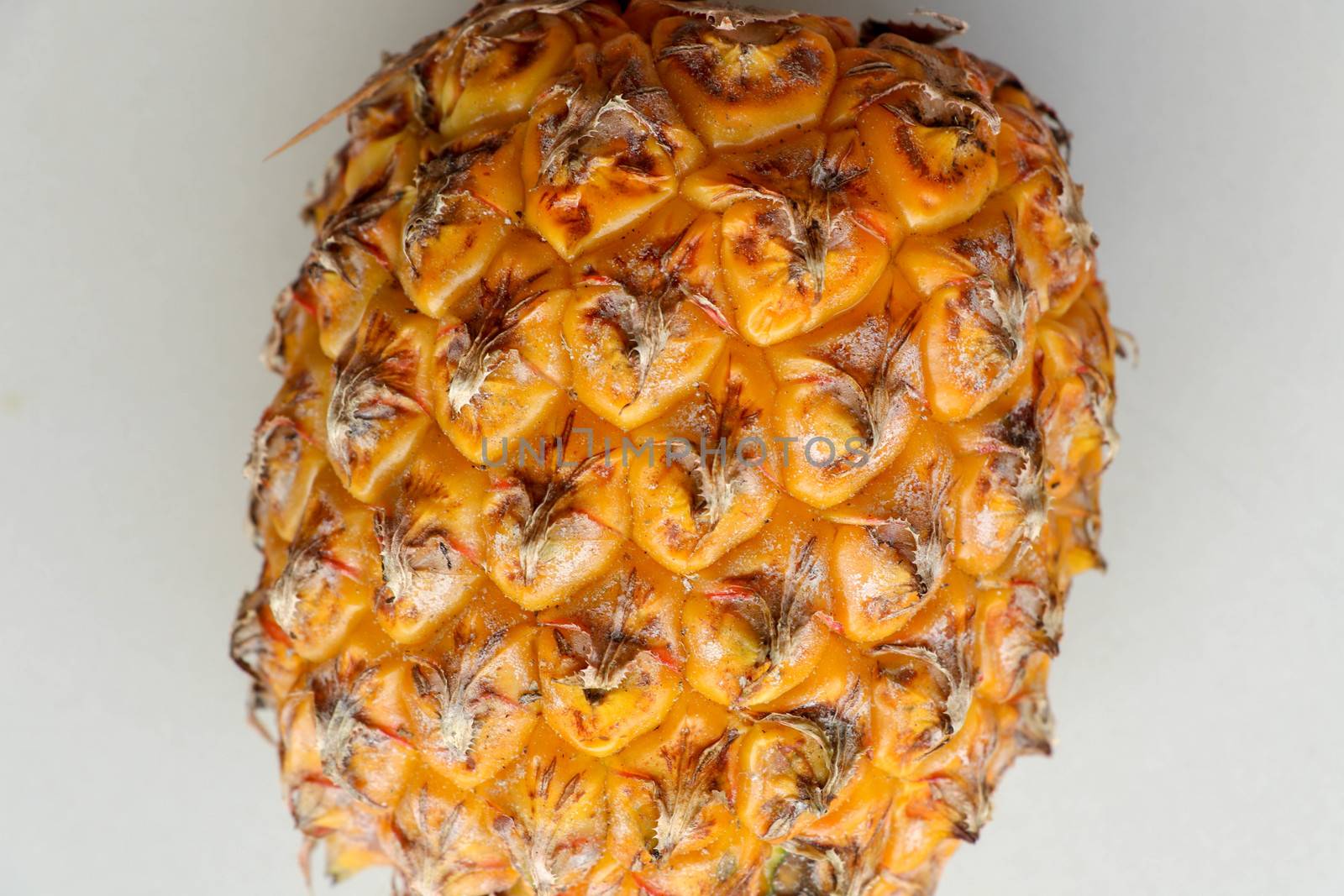 Close-up of skin of ripe pineapple. Fresh pineapple texture. Abstract nature background texture of pineapple skin. The skin is were most of the bromelain, a protein that helps in digestion and healing