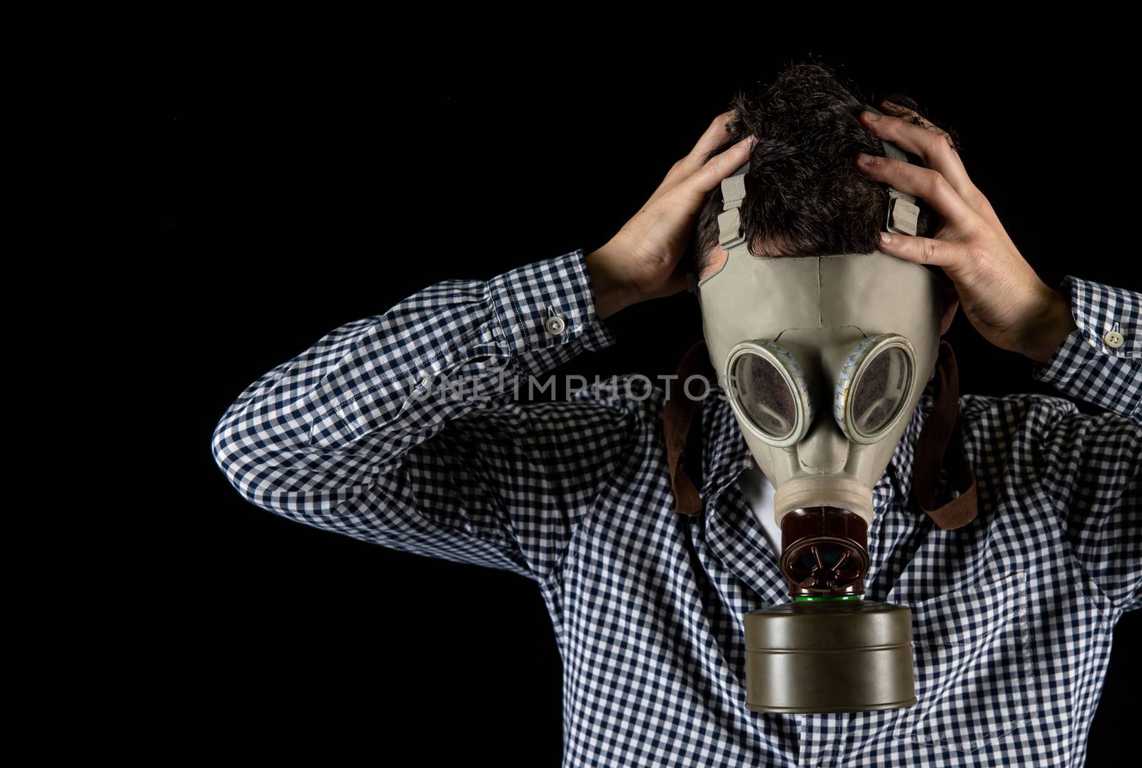 a man in a gas mask is worried about the current situation by Edophoto