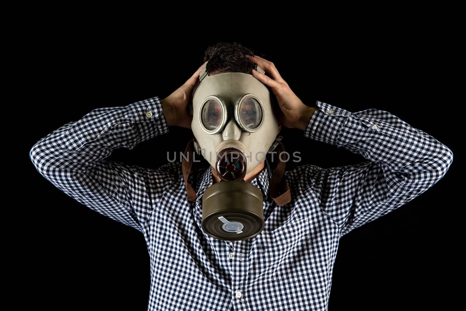 a man in a gas mask is worried about the current situation by Edophoto