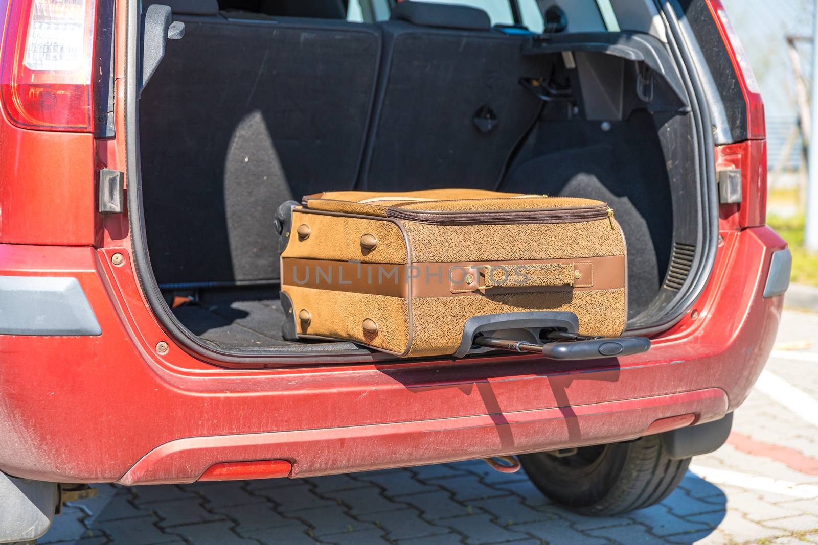 luggage in the trunk of a passenger car.