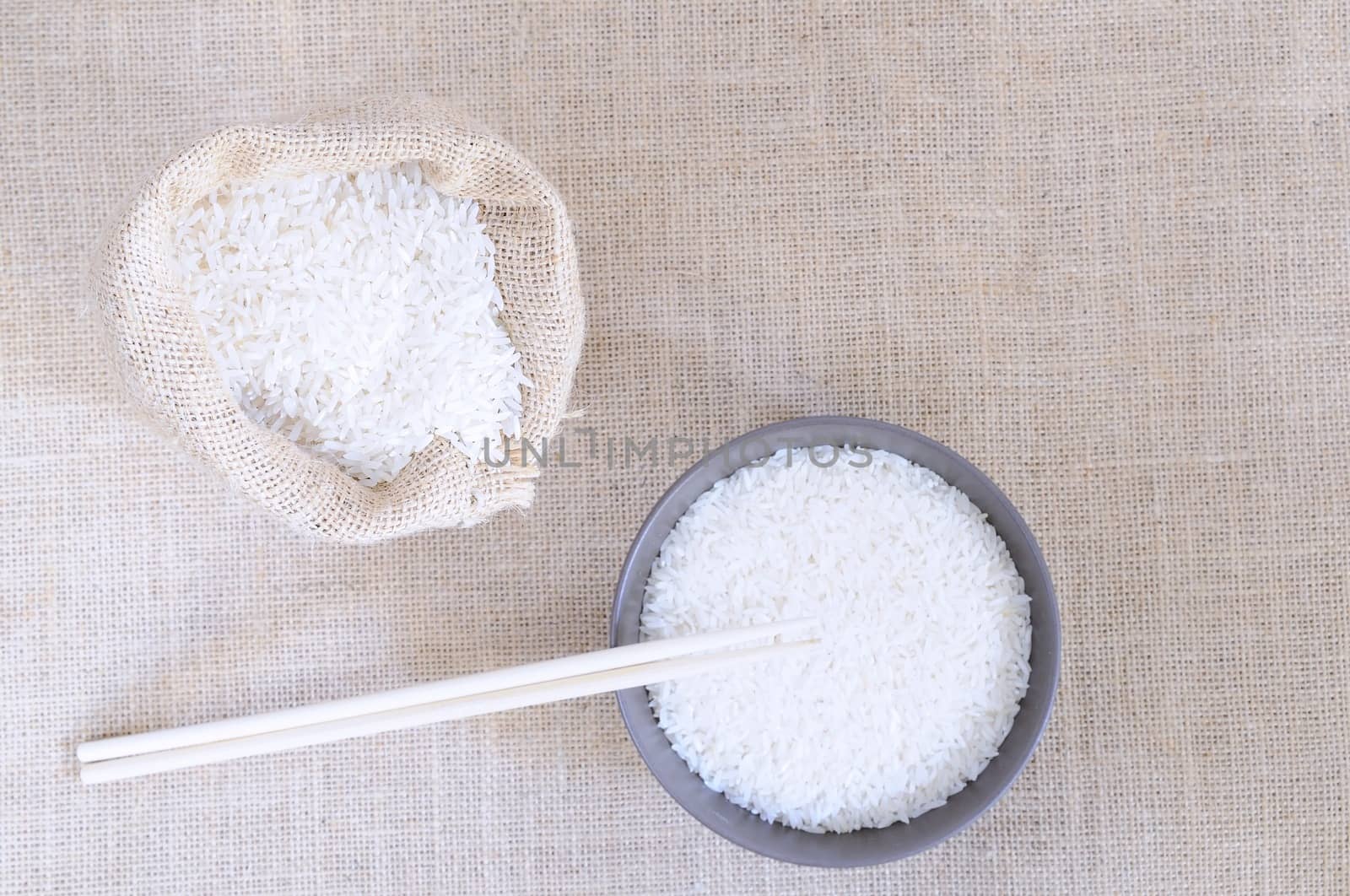 Sack of rice and bowl on a burlap.